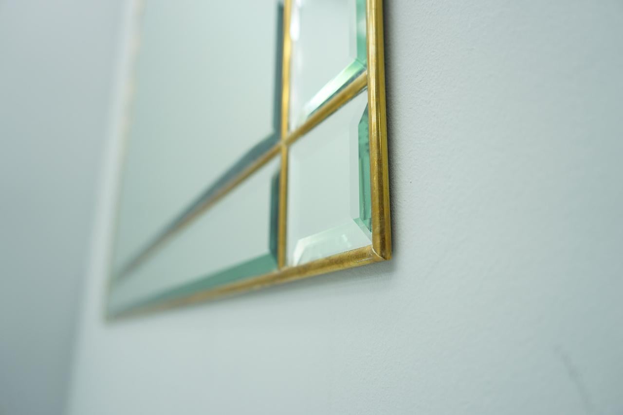 Beautiful wall mirror finely worked with facets glass and brass, France, 1970s

Very good condition.
 