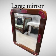 Large wall mirror with stitched leather by Jacques Adnet