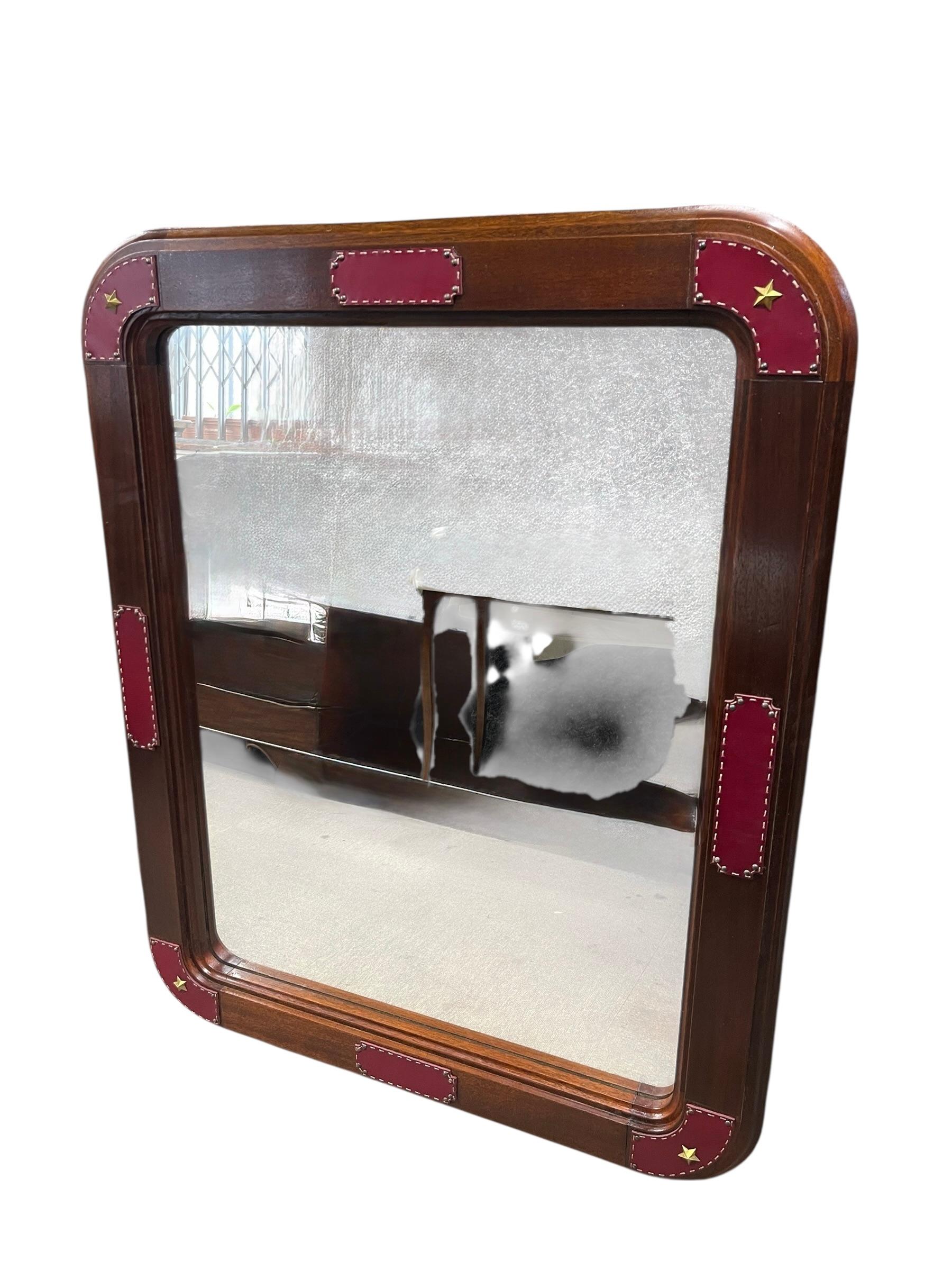 Français Large wall mirror with stitched leather by Jacques Adnet en vente