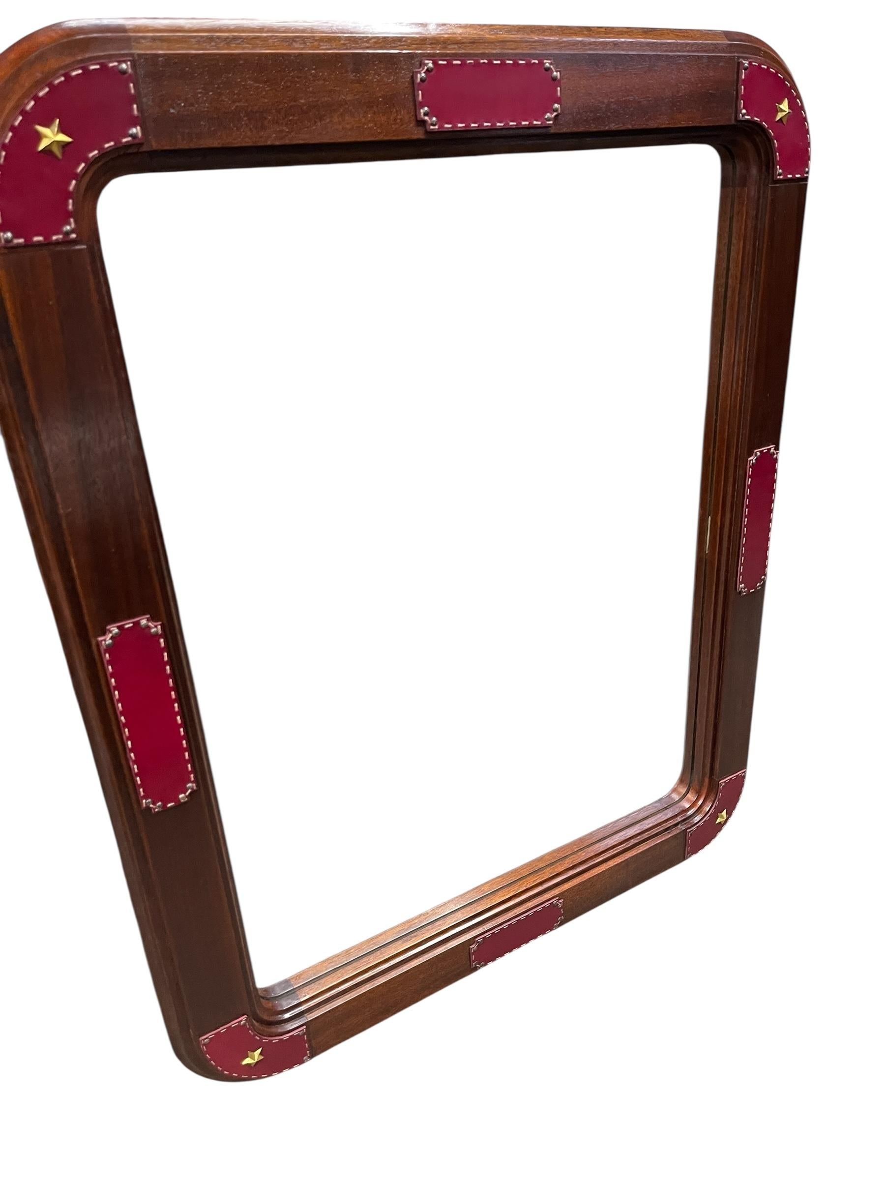 Cuir Large wall mirror with stitched leather by Jacques Adnet en vente