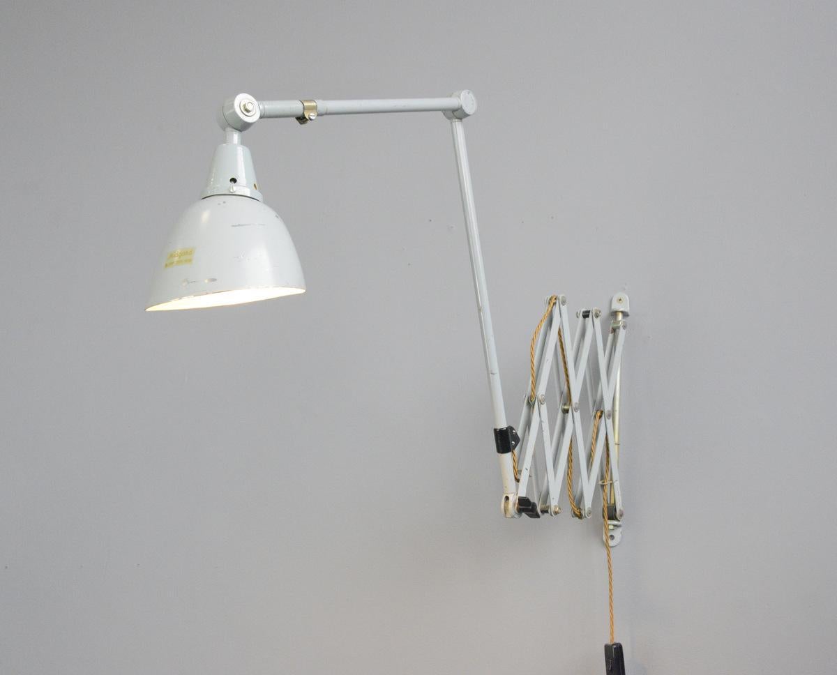 Large wall-mounted scissor lamp by Midgard, circa 1960s.

- Large extendable scissor mechanism
- Two large articulated arms
- Aluminium shade with original gold makers label
- Takes E27 fitting bulbs
- German, circa 1960s.
- Shade measures: