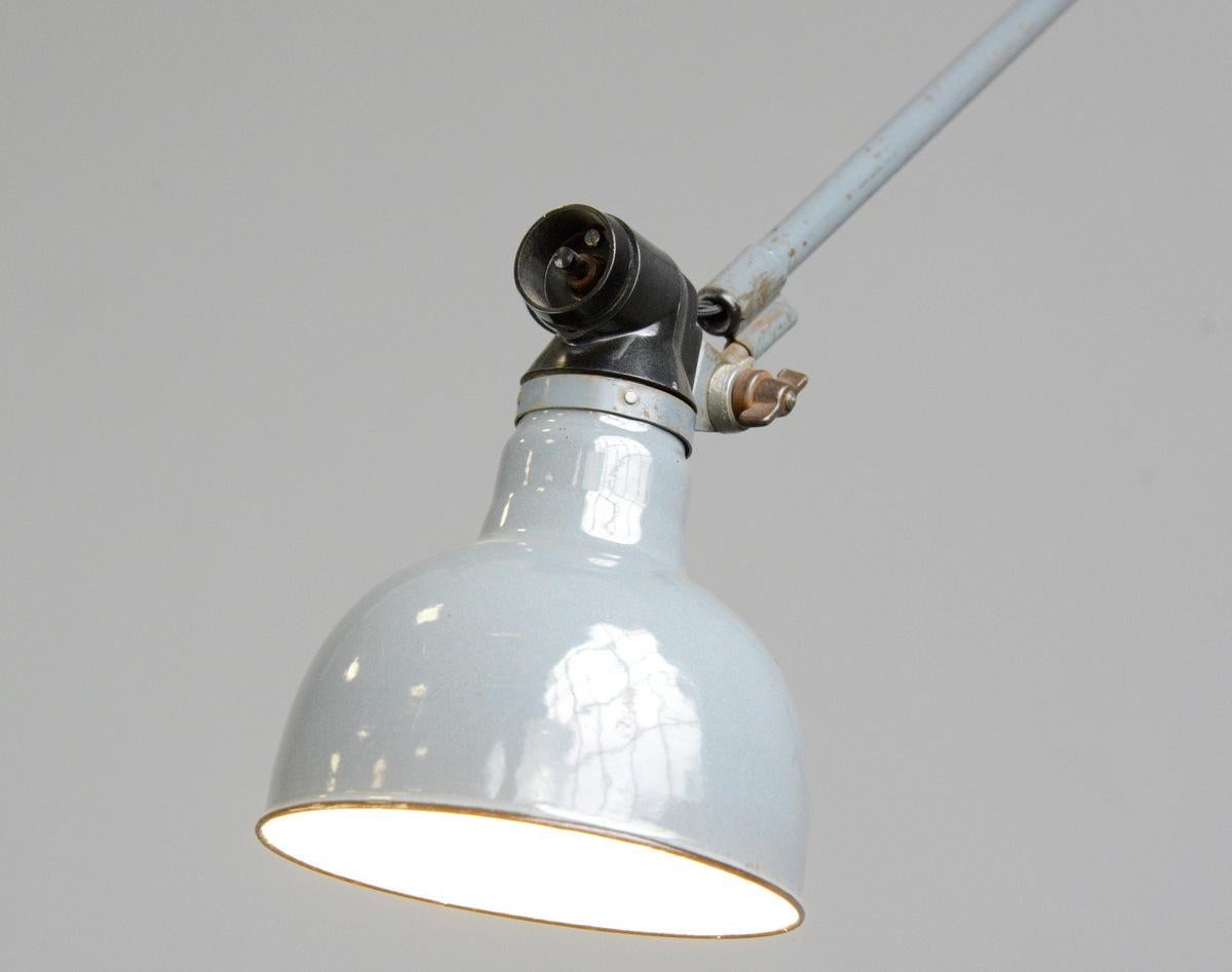 Large wall-mounted task lamp by Rademacher, circa 1930s

- Vitreous grey enamel shade
- Bakelite switch
- Takes E27 fitting bulbs
- Tubular steel articulated arms
- By Ernst Rademacher
- German, 1930s
- Shade measures 16 cm wide
- Extends