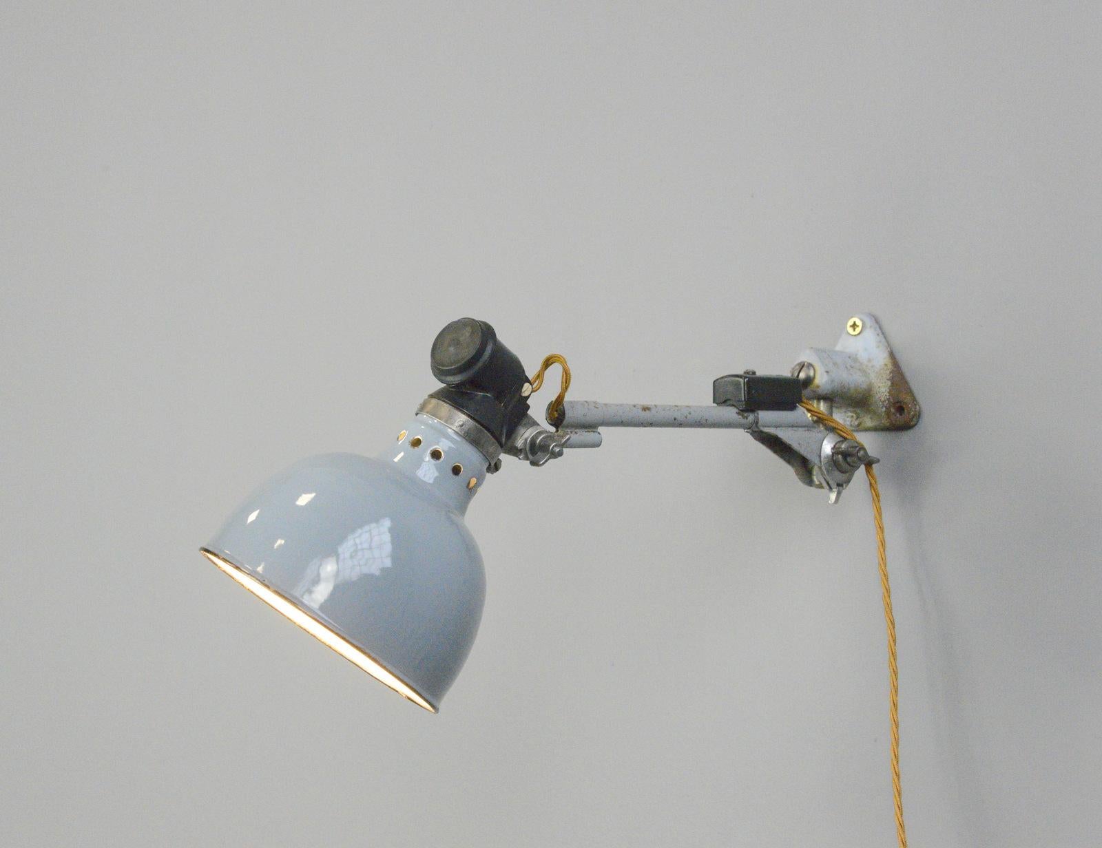Large wall mounted task lamp by Rademacher Circa 1930s

- Vitreous grey enamel shade
- Bakelite switch
- Takes E27 fitting bulbs
- Tubular steel articulated arms
- By Ernst Rademacher
- German ~ 1930s
- Shade measures 16cm wide 
- Extends