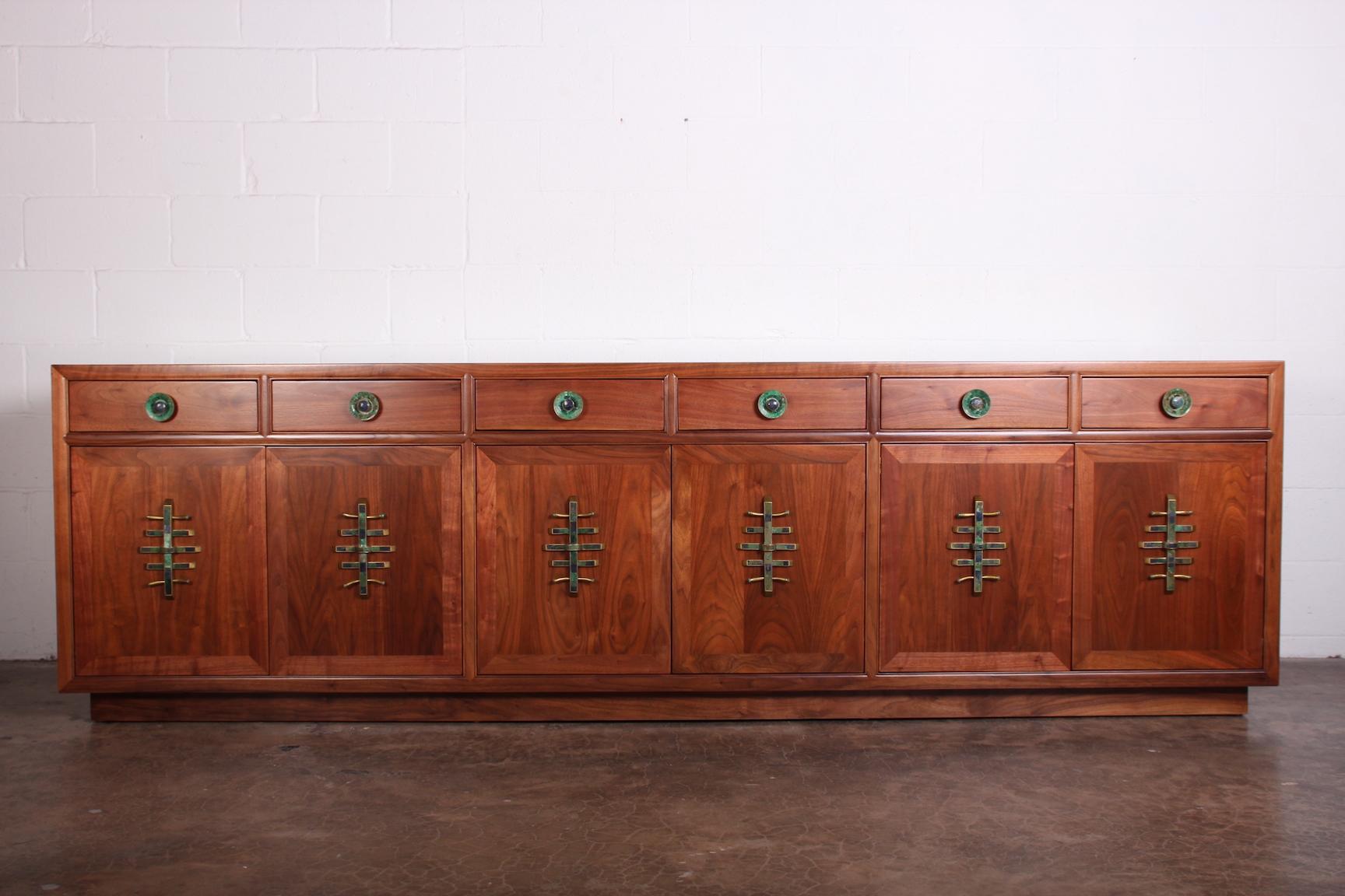A large walnut cabinet by Baker with hardware by Los Castillo.