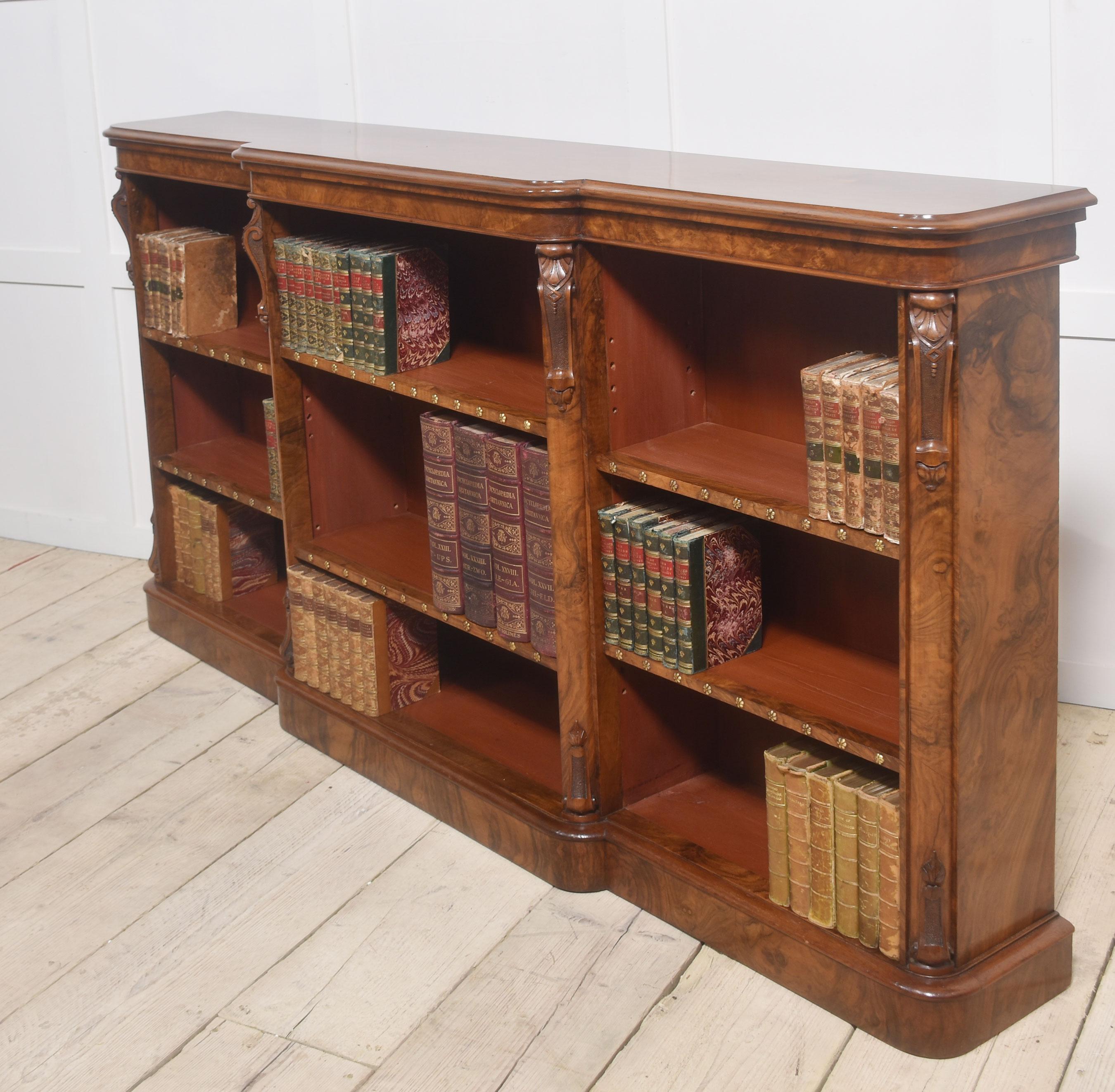 Walnut open bookcase, the large impressive rectangular breakfront top. Above three bays of adjustable shelves divided by scrolling capped columns. All raised on a plinth base.
Dimensions
Height 38.5 Inches
Width 72 Inches
Depth 12.5 Inches