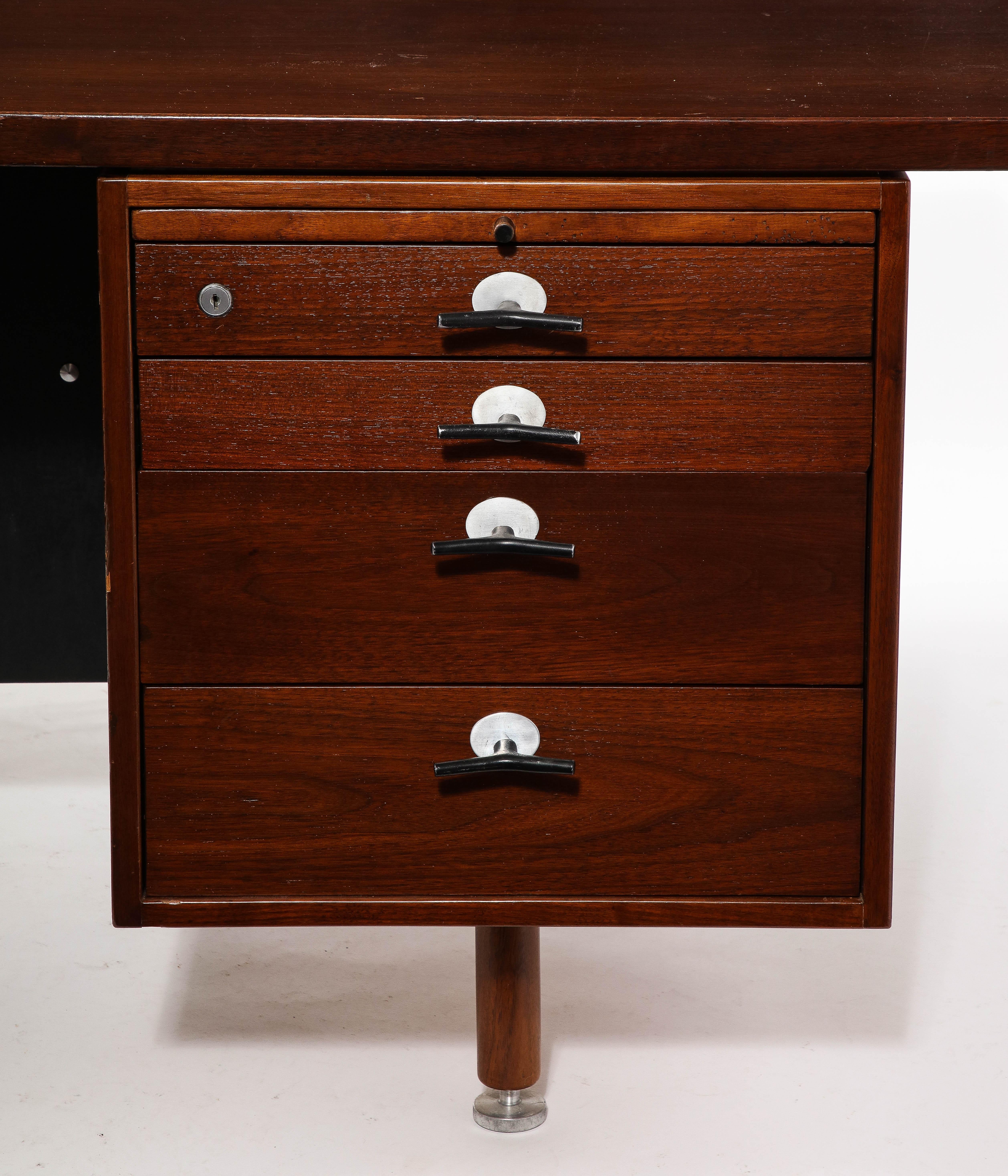 A large and handsome executive desk constructed of solid walnut with 