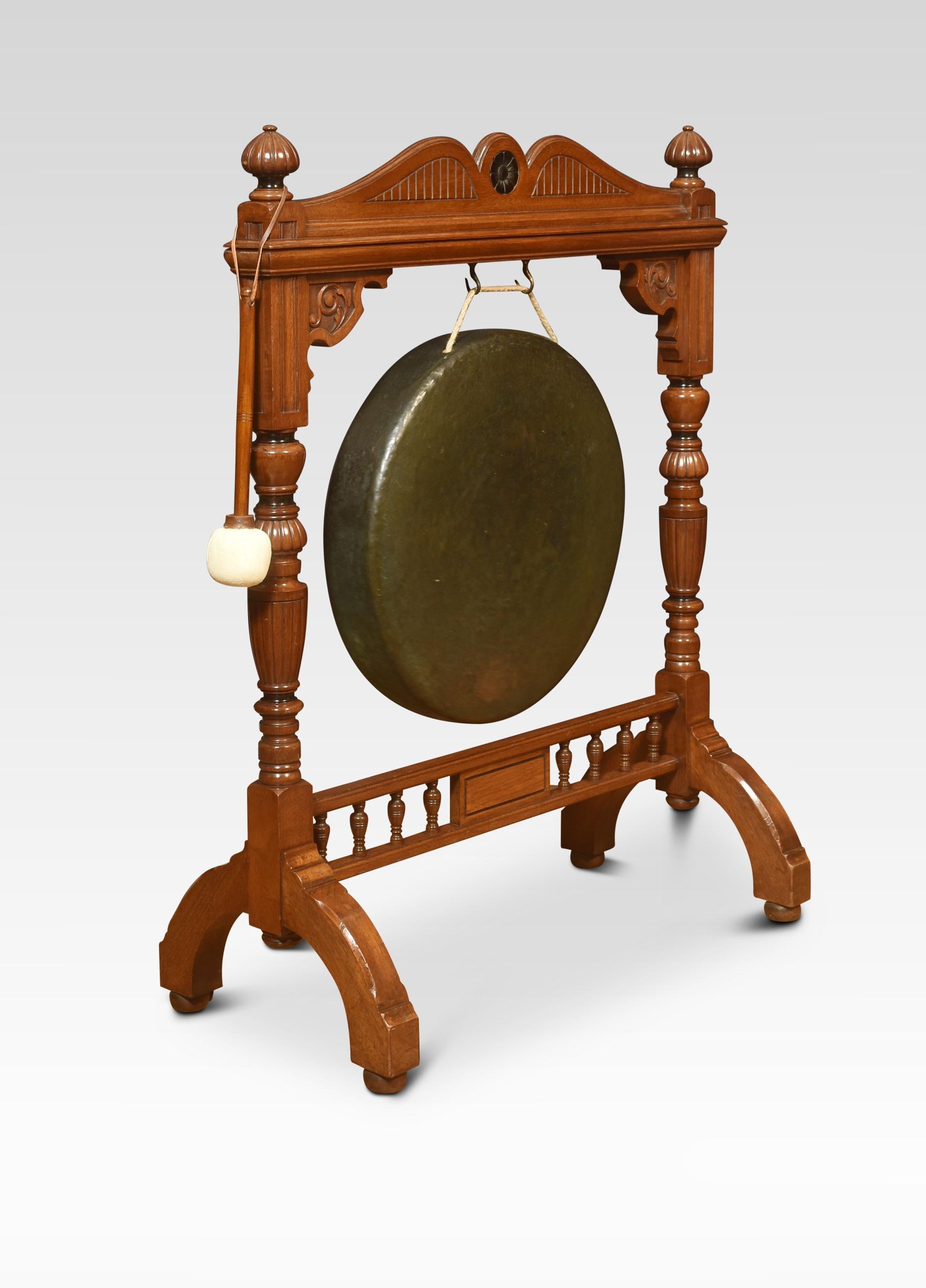 Large carved walnut dinner gong, the frame with scrolling decoration. Flanked by carved fluted uprights, supporting the original gong. All raised up on trestle base, with a striker.
Dimensions
Height 43 inches
Width 33 inches
Depth 16 inches.