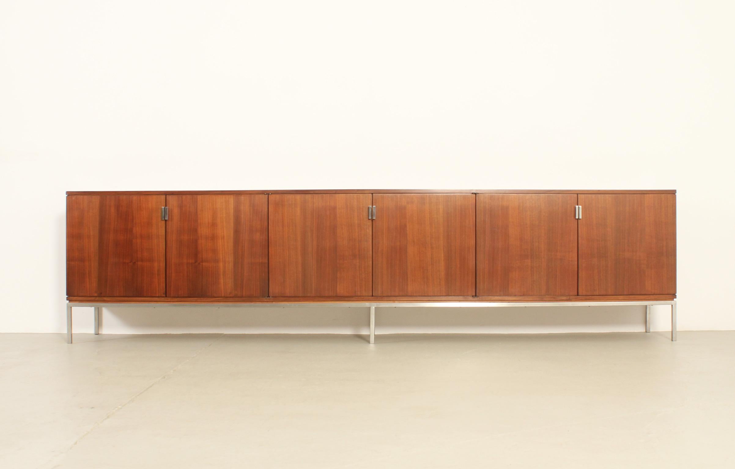 Large sideboard designed in 1960's by Spanish designer Rafael García who was the head of Knoll stores in Spain. Probably custom made for a customer in walnut wood and polished steel. Six door with five open spaces with shelves and five drawers in