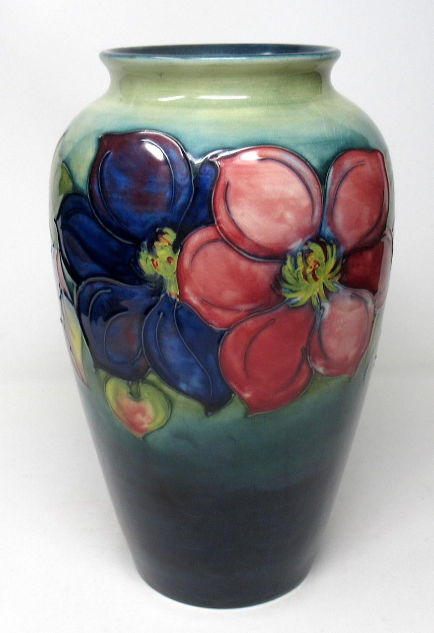 

An Exceptionally Fine Large Walter Moorcroft Tube Lined Floral Flambe Glazed Baluster shaped body with everted rim Vase in Anemone Pattern. 

The main decorated in flambe glaze with tonal reds to deep sea greens and blues. 

Condition: Mint