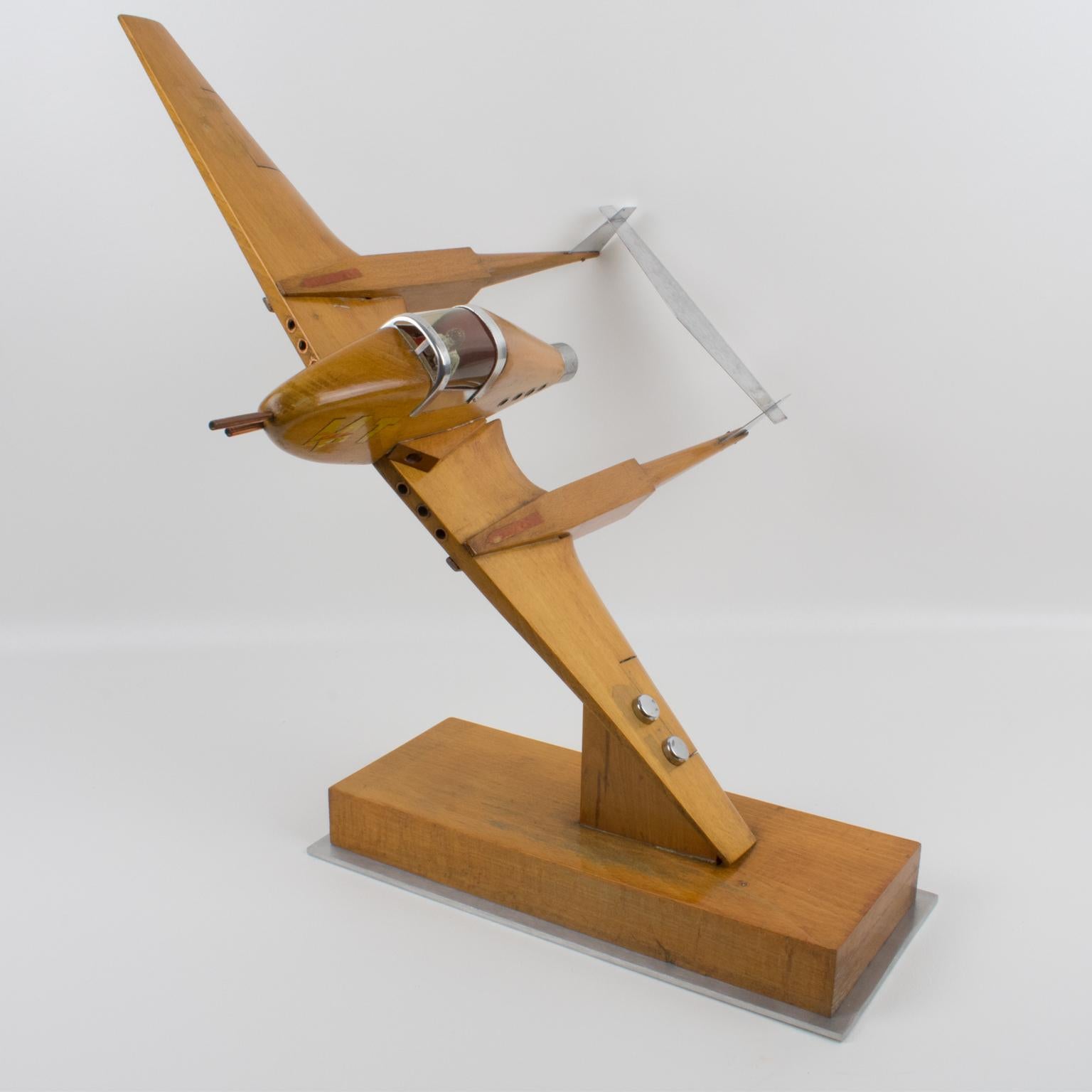 Stunning war airplane aviation model. It is a large wooden airplane model with lots of details accents, visibly equipped for aerial combat with cannons and machine guns. Stands on thick wood and aluminum plinth. The airplane is even complete with