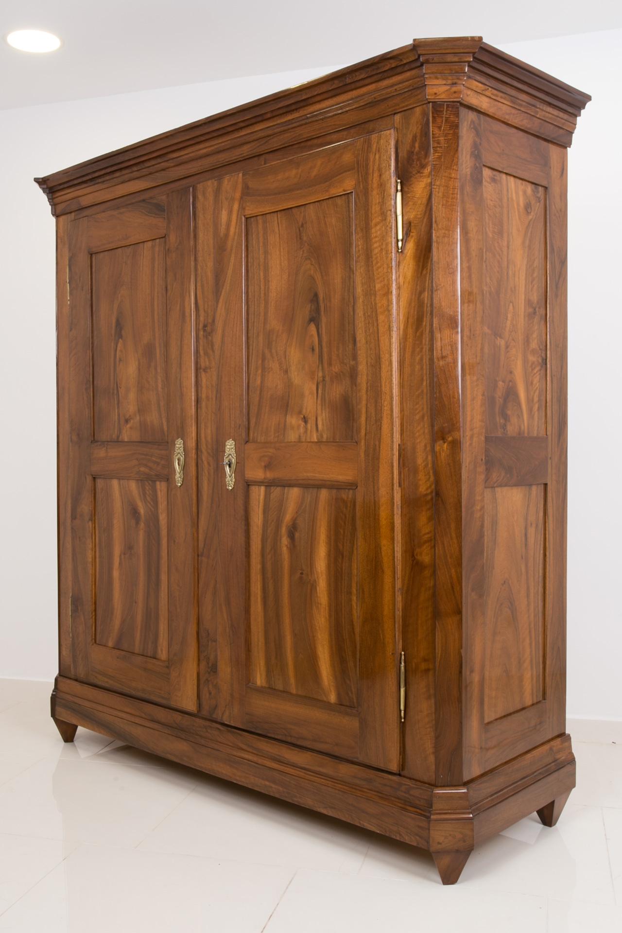 This magnificent wardrobe comes from Germany and was made around late 18th or early 19th Century. It is made of solid walnut wood. It has undergone a professional renovation process with highest care to every little detail to preserve the unique