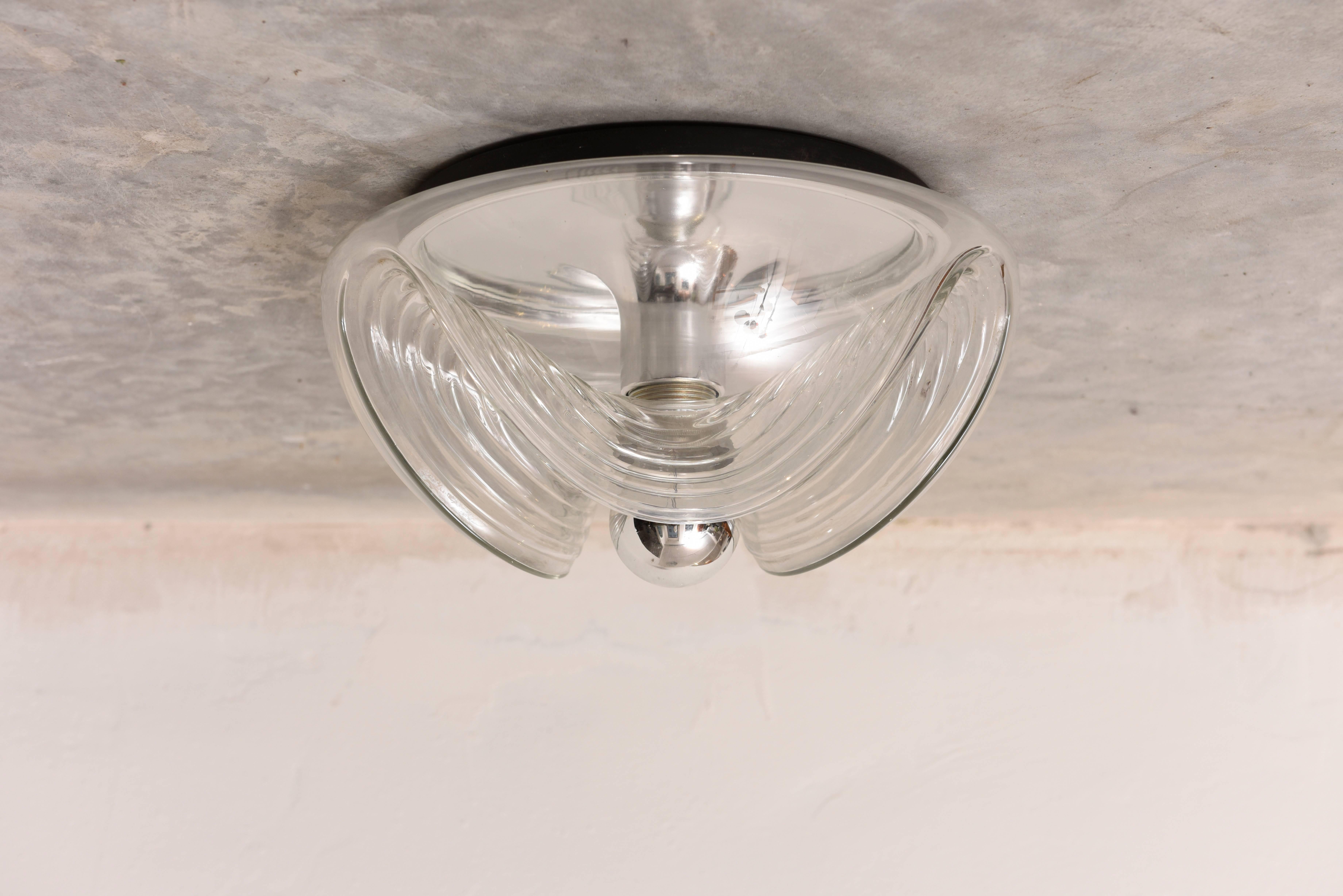 Large round wave clear glass ceiling light, flush mount designed by Peill & Putzler, Germany, 1970s.
These lamps won the IF Design award in 1975. Glashüttenwerk Peill und Sohn was founded in 1903 in Düren, a small town in Germany. Peill und Sohn