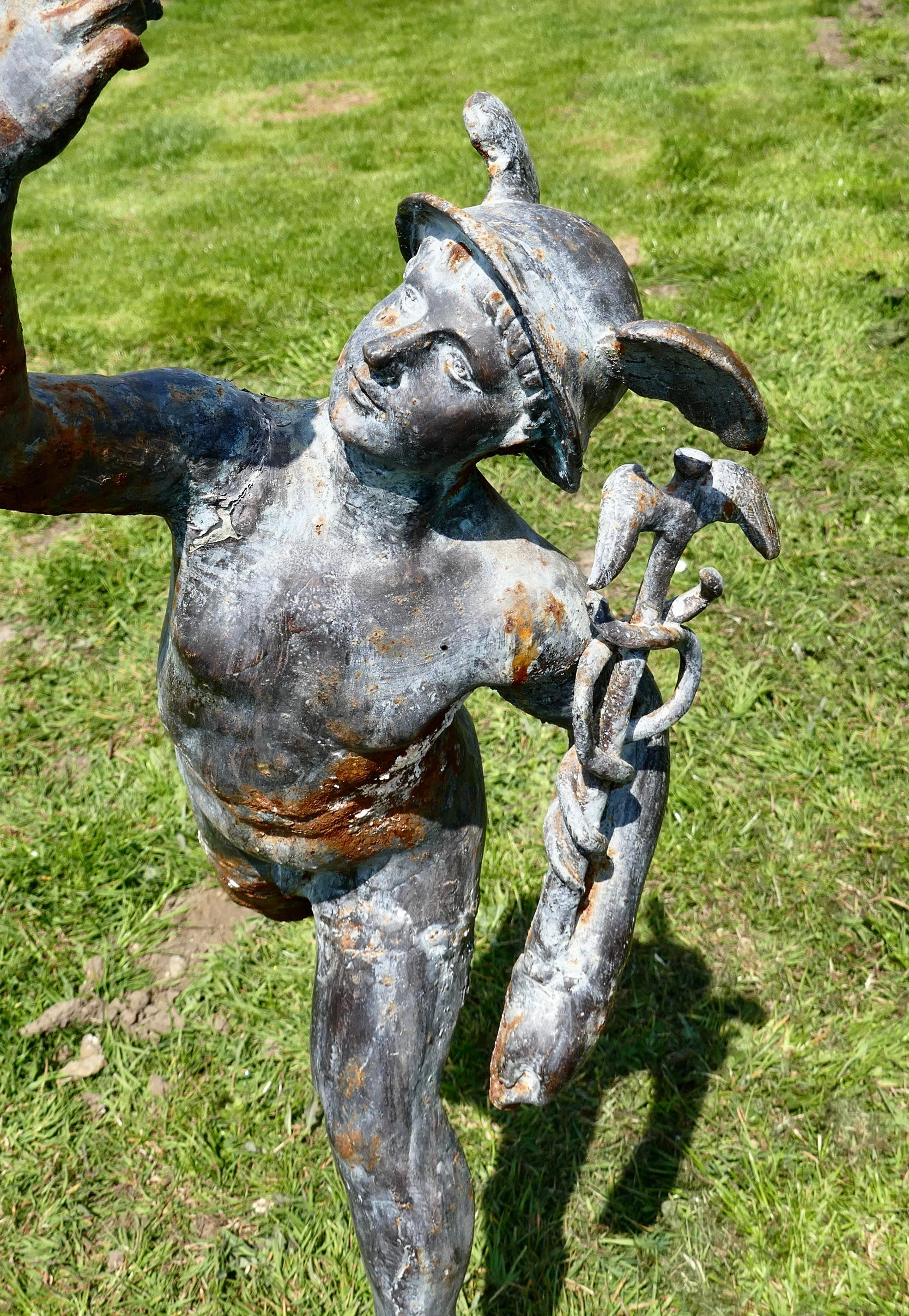 Large weathered iron garden statue of mercury (Hermes) the winged messenger

The statue is very heavy it is almost 4ft tall and made in Iron, it has been outside for many years it has a good weathered finish and in sound condition
 Mercury is