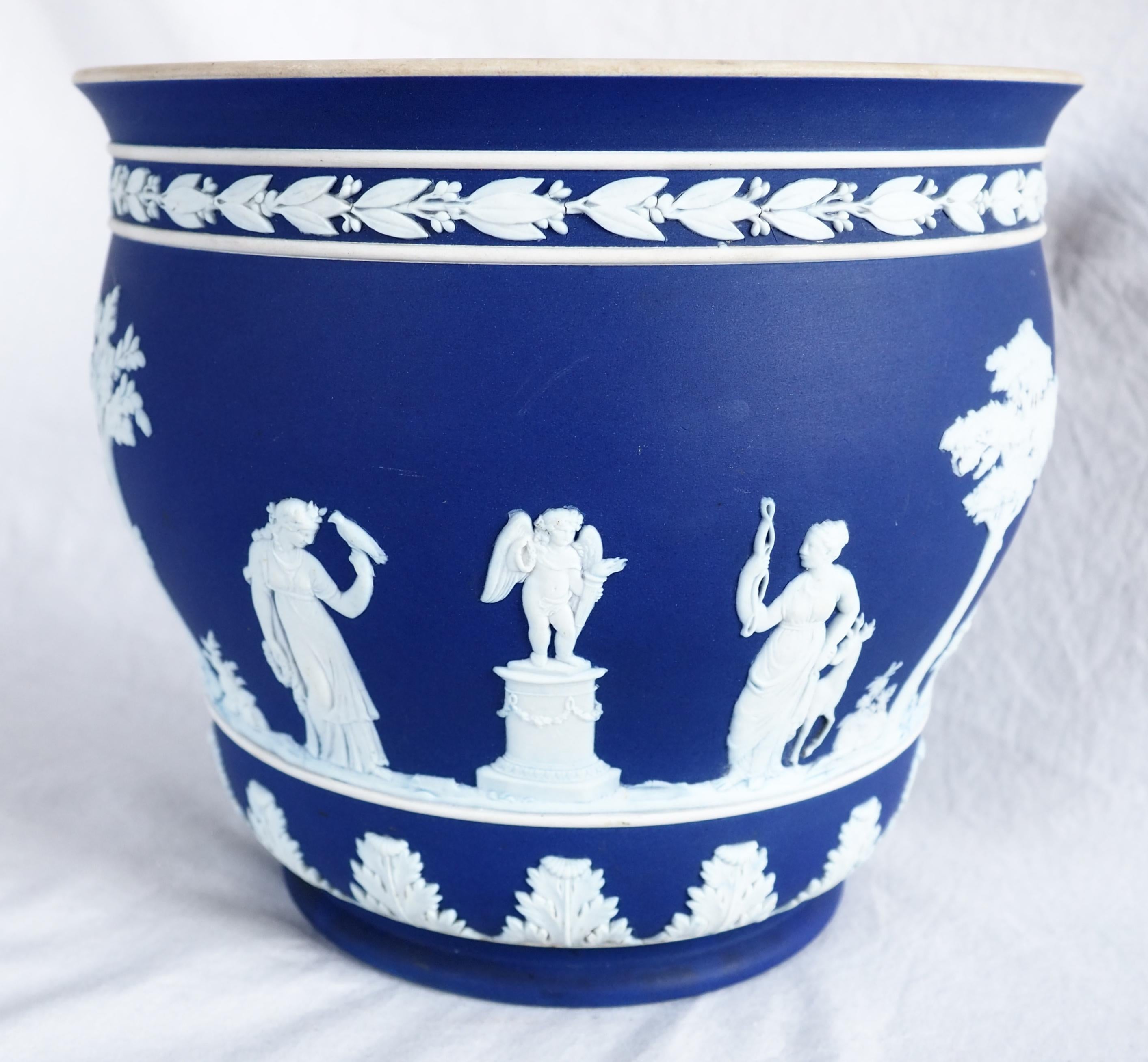 A fine Wedgwood jasperware cachepot / jardiniere / planter, beautiful neoclassical style item decorated with white antique-style scenes on a strong-blue background. Second half of 19th century or circa 1900.
Jasperware, or jasper ware, is a type of