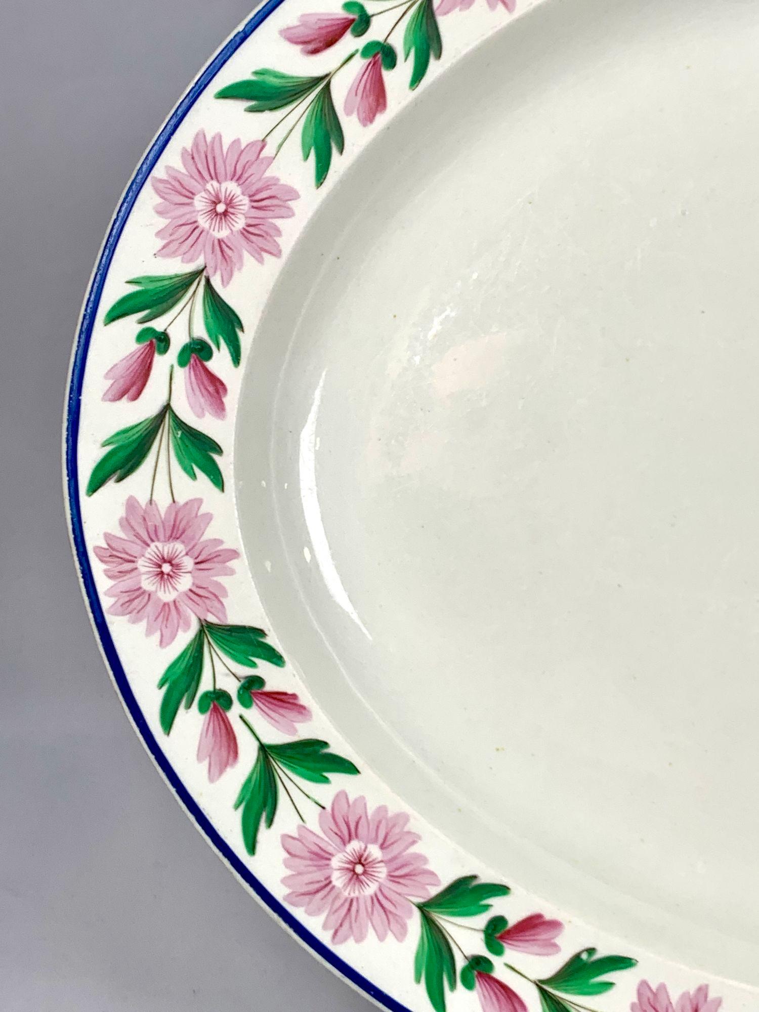 This large Wedgwood creamware platter, made in the early 19th century, is decorated with a beautiful band of pink daisies with green leaves.
The pink and green complement each other perfectly.
It’s a happy pattern!
Marks: the “WEDGWOOD” mark is