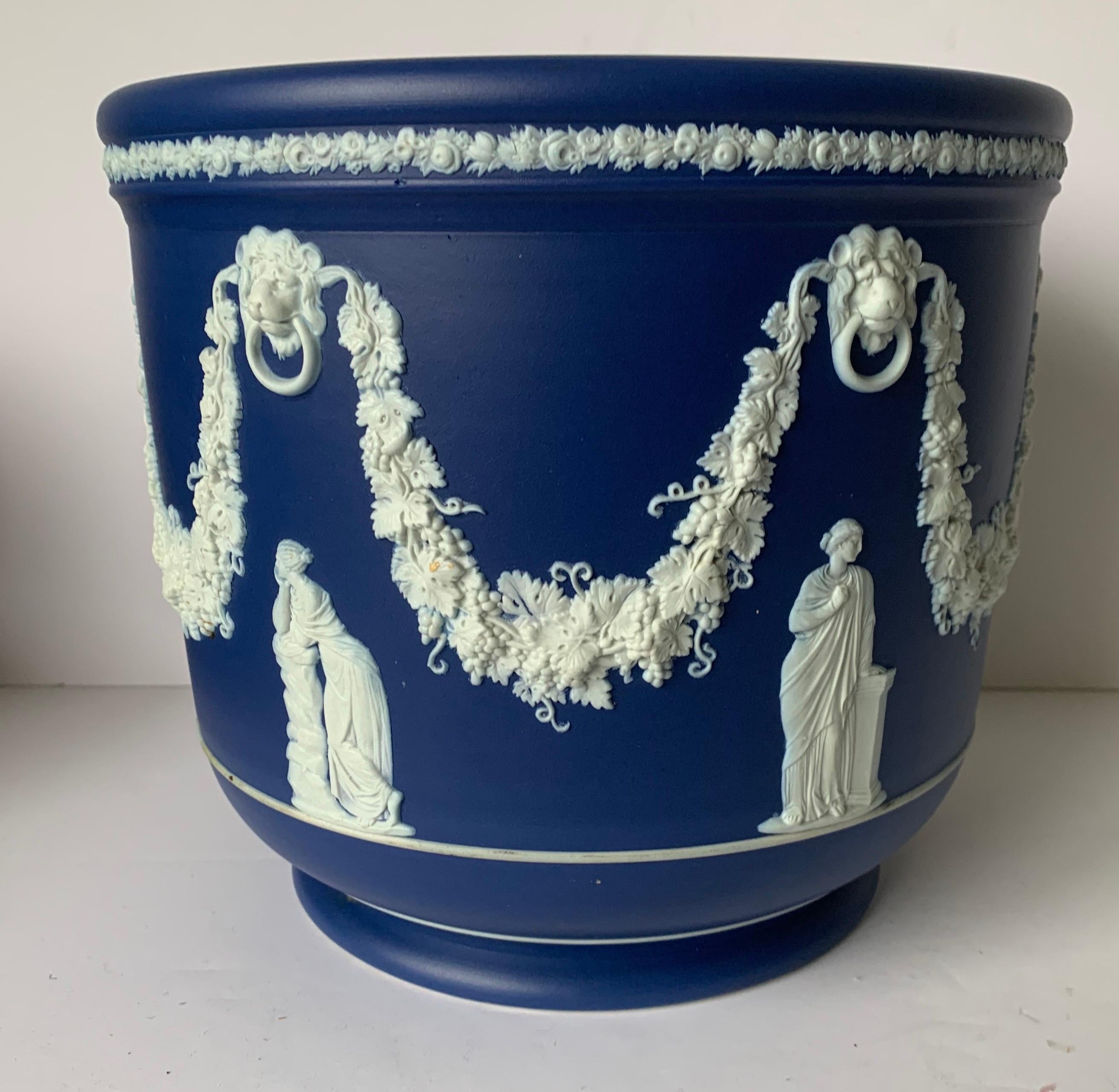 Large Wedgwood dark blue Jasperware jardinière. All-over neoclassical motif. Stamped on the underside. This is the largest example of Wedgwood I have come across. The Last image is for comparison to show how large this piece is compared to a smaller