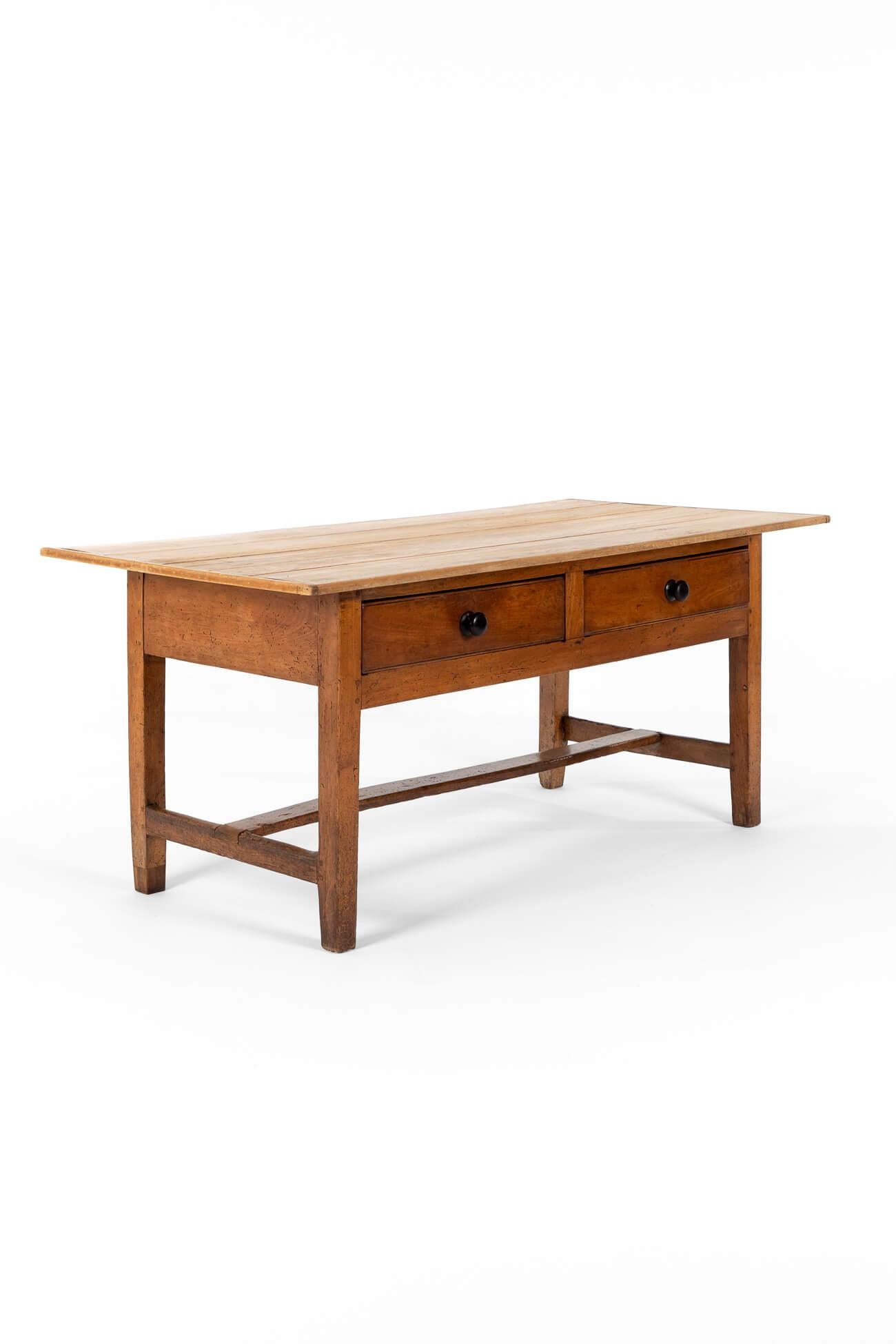 A delightful Welsh dairy table with a smooth scrubbed pine top.

The large fruitwood base has two smooth-running frieze drawers with ebony handles.

United by a superb H-shaped stretcher and finished in the most glorious shade of rich honey.

Welsh,