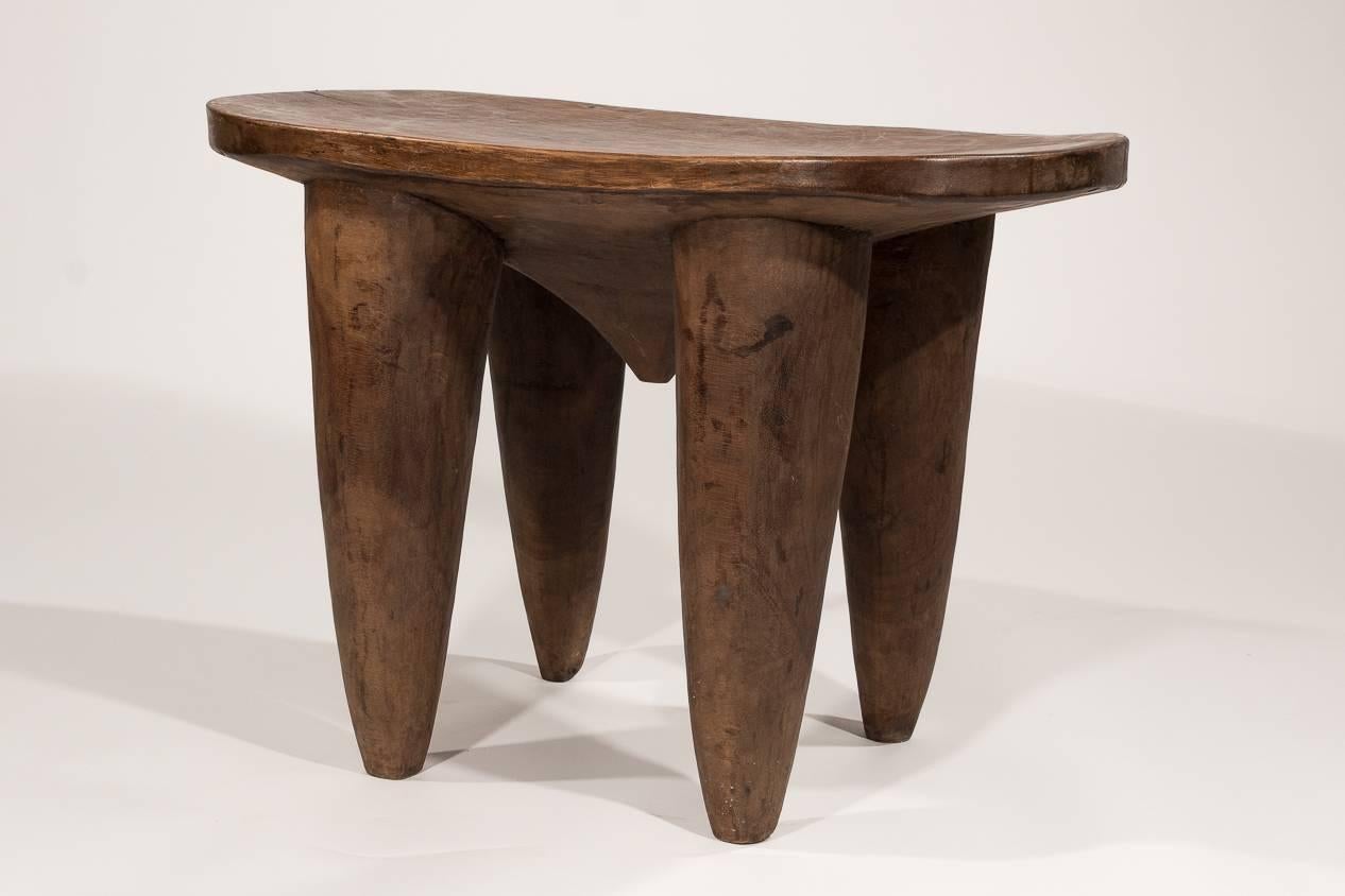 This large, wooden stool is really a great example of functional sculpture. A great accessory for any modern room.