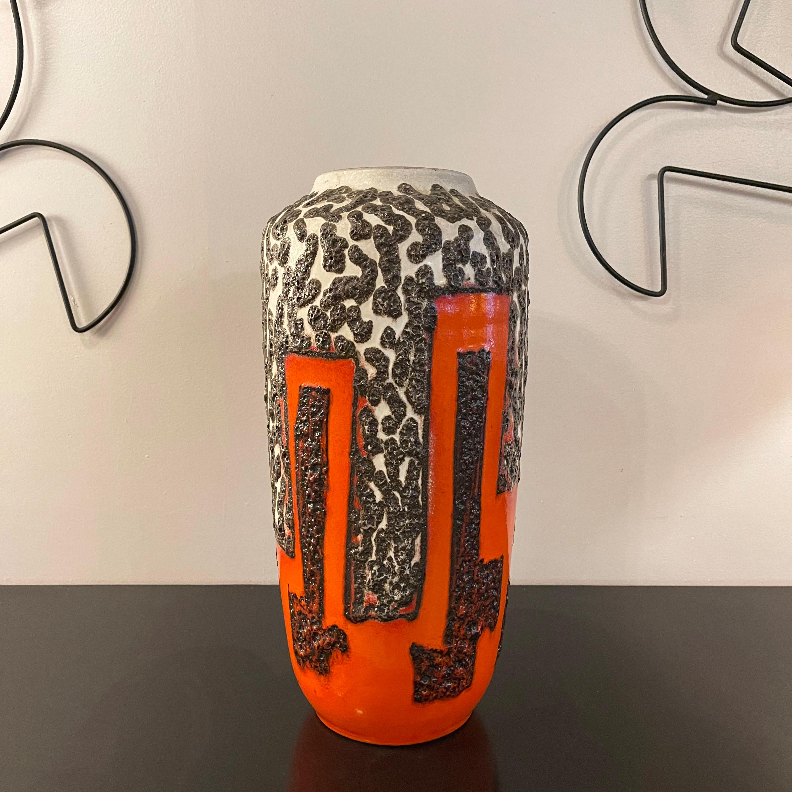 Large, statuesque, West German, mid century modern, Fat Lava art pottery vase by Scheurich Keramik features a striking, black, white and orange, brutalist glaze. The mouth opening measures 4.5 inches.