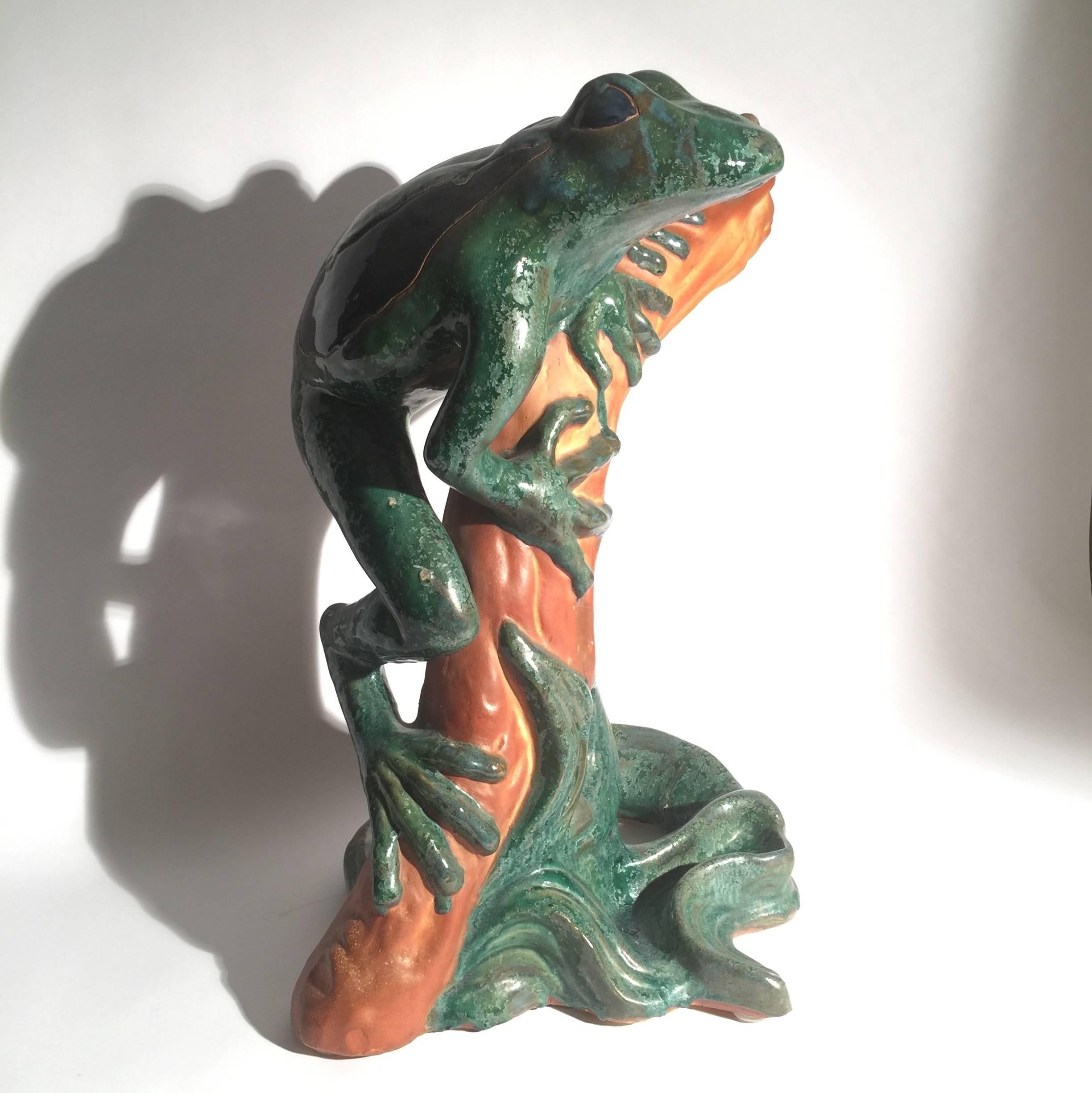 Whimsical mid-20th century sculpture of a frog on branch. Vibrant color and unexpected size.