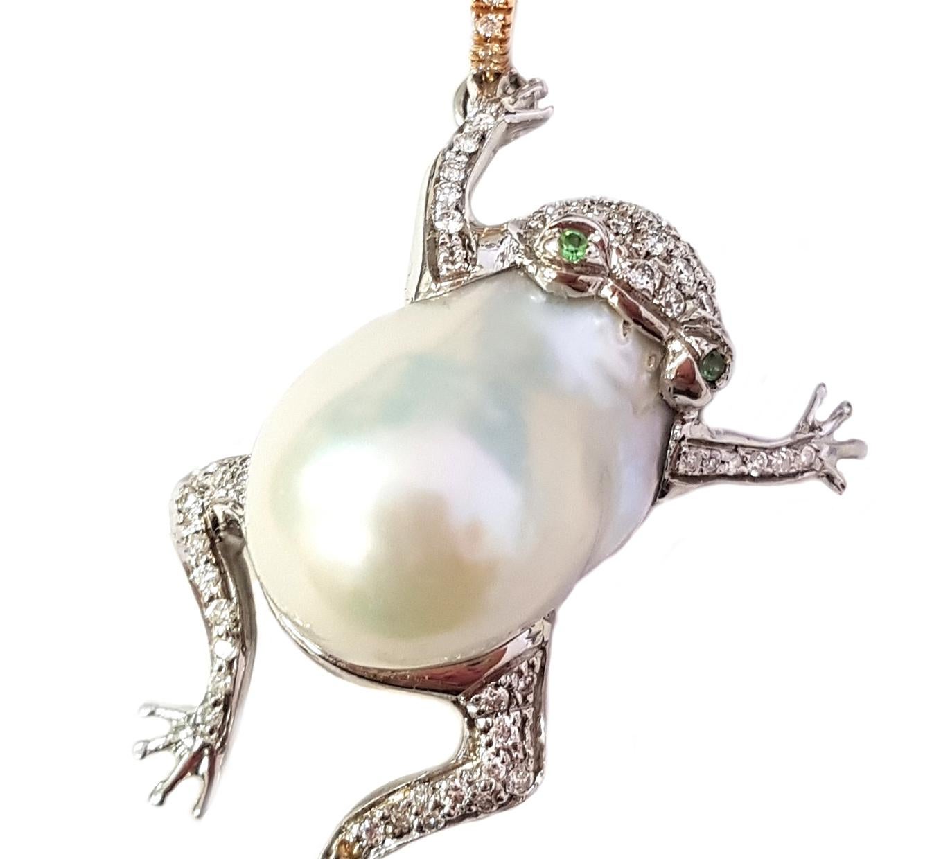 This lovely, entirely handmade pendant is made of a large Australian pearl fancifully reimagined in the form of a leaping frog. The head and legs of the frog are set with white diamonds, and two small tsavorites create brilliant, winking green eyes.