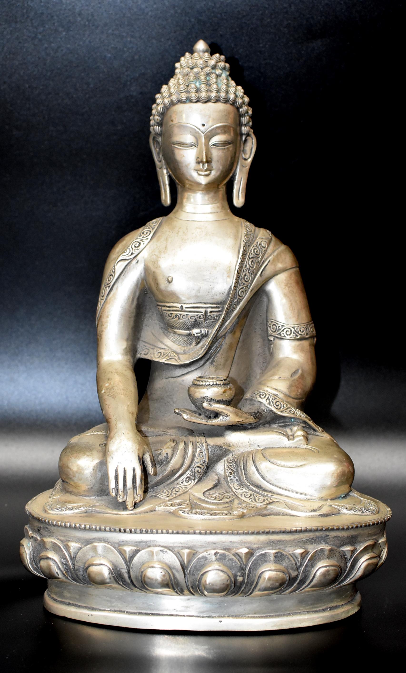 A beautiful white brass Buddha statue. The mudra is reaching the earth, gather and spread the blessing. Buddha is seated on a lotus throne, symbol of peace and harmony. Beautiful depiction of hair and hands.