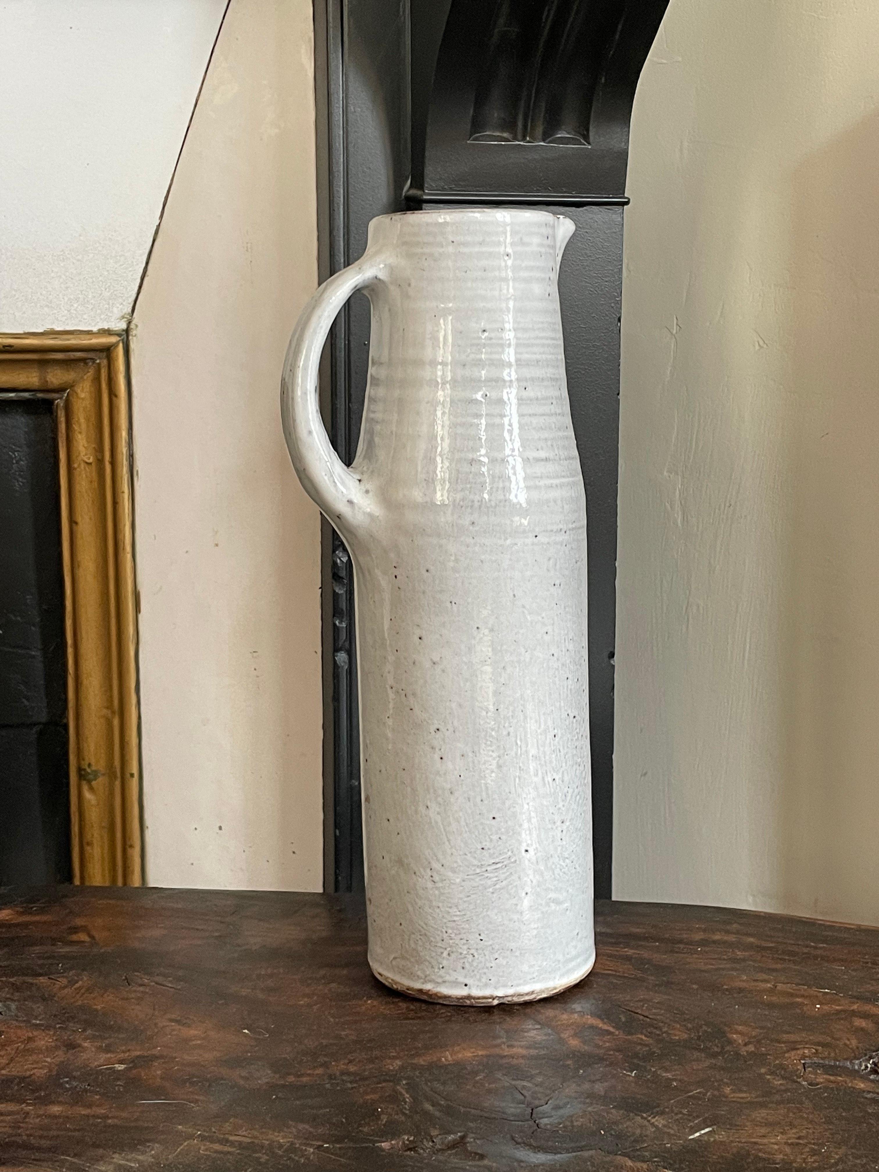 Large white ceramic pitcher by norbert pierlot,
Made in ratilly in the 60's, signed and stamped.
Very fine workmanship.

Dimensions: 31cm, diameter at base: 10cm.