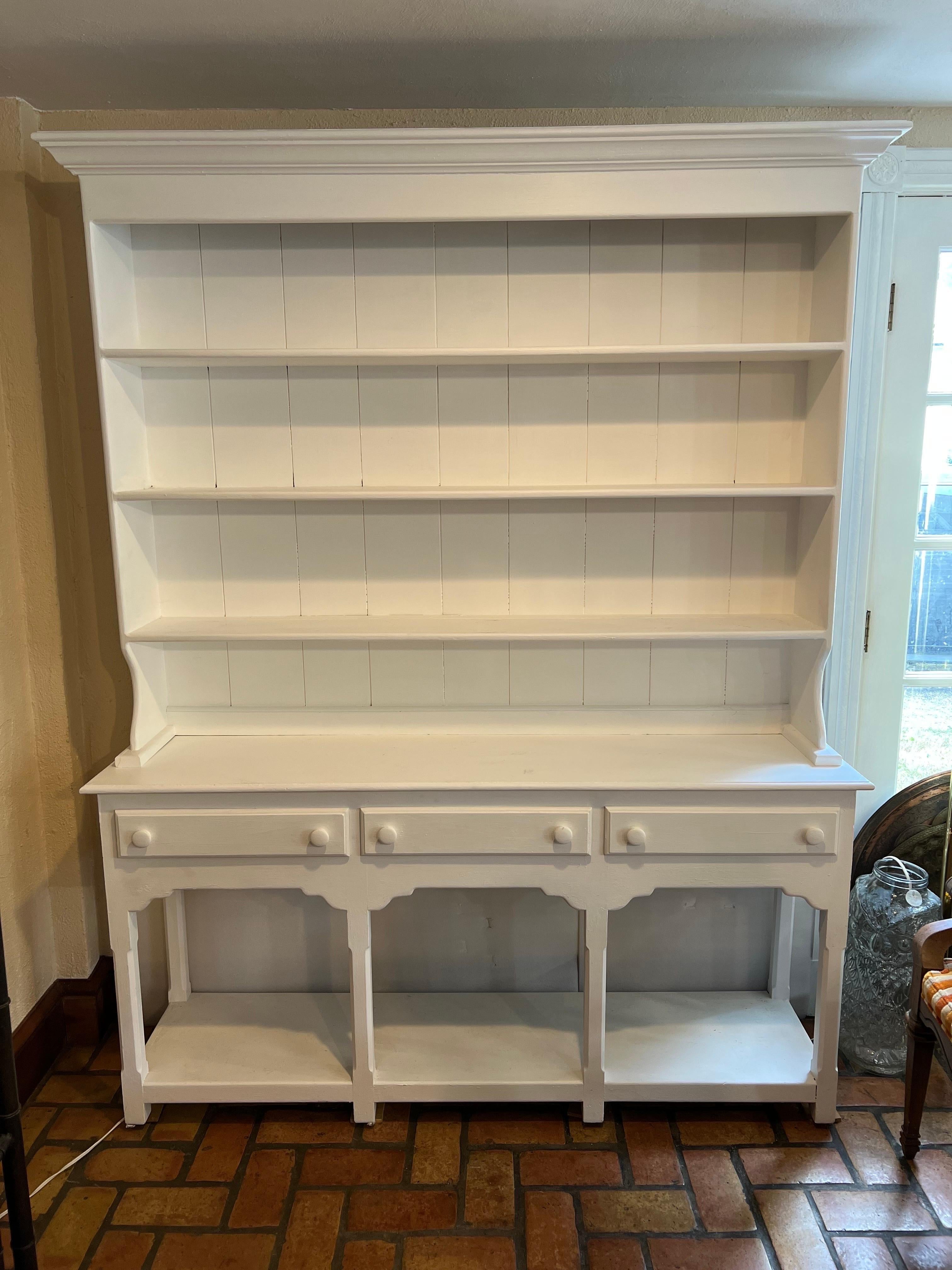 Large white chalk paint hutch with drawers. Use as a bookcase or to display your China. Three ample drawers for silverware and a total four large shelves on top and one at the bottom. If you are a pottery collector this is the perfect piece. All of