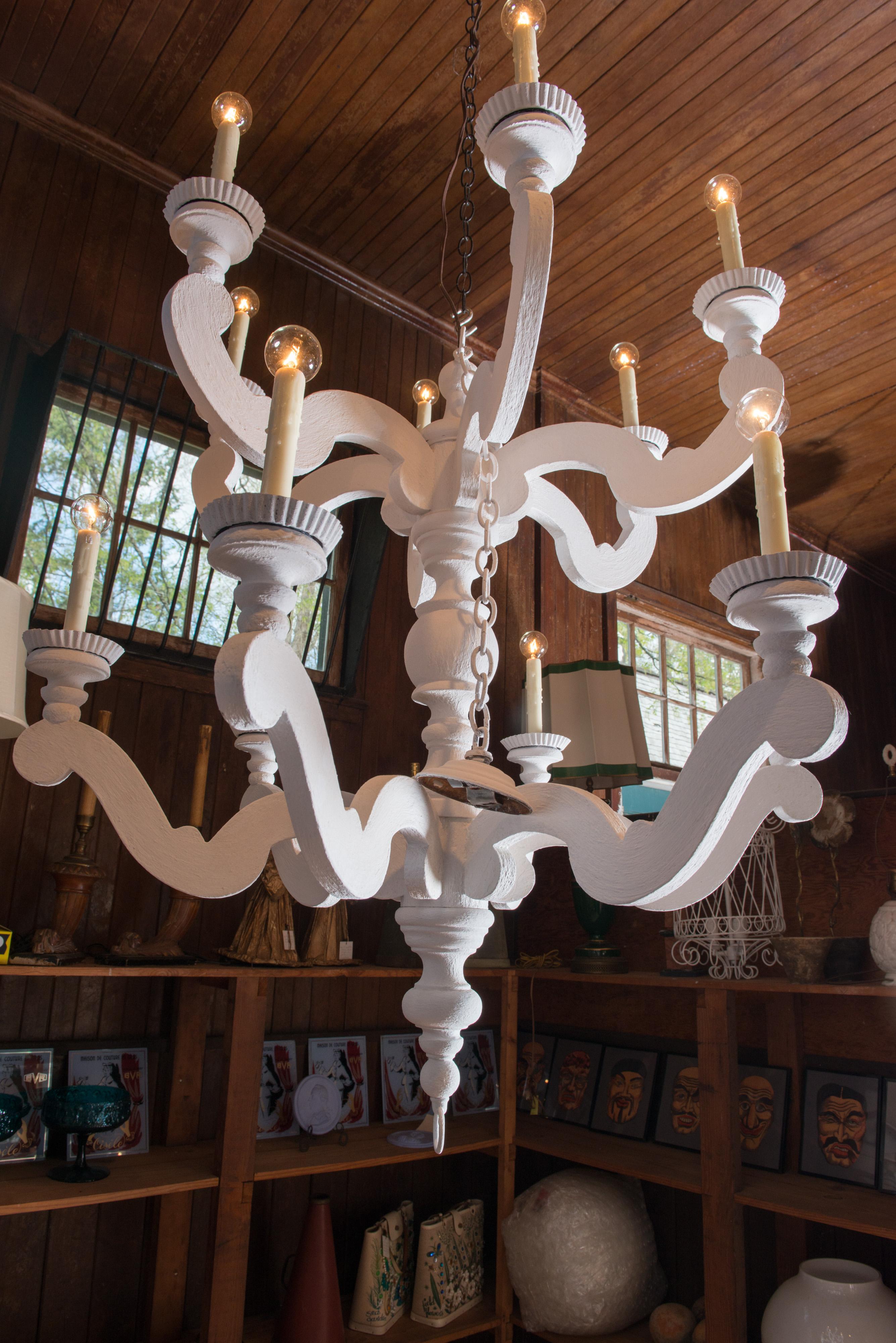 Large twelve arm chandelier with ceiling canopy. A distressed finish with a plaster like look. A man made material. Excellent for a pool house or a pergola or any large room. 2400A dramatic and big look! Attributed to Holly Hunt.