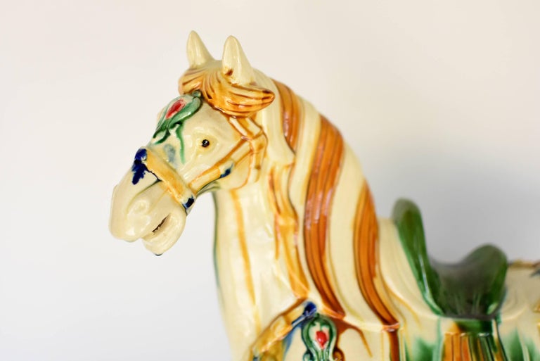 A majestic, large, white butterscotch San Cai horse in high gloss. The Sancai technique dates back to the Tang dynasty (618–907AD). This wonderful piece has all the hallmarks of Tang San Cai terracotta potteries with skilfully applied glaze