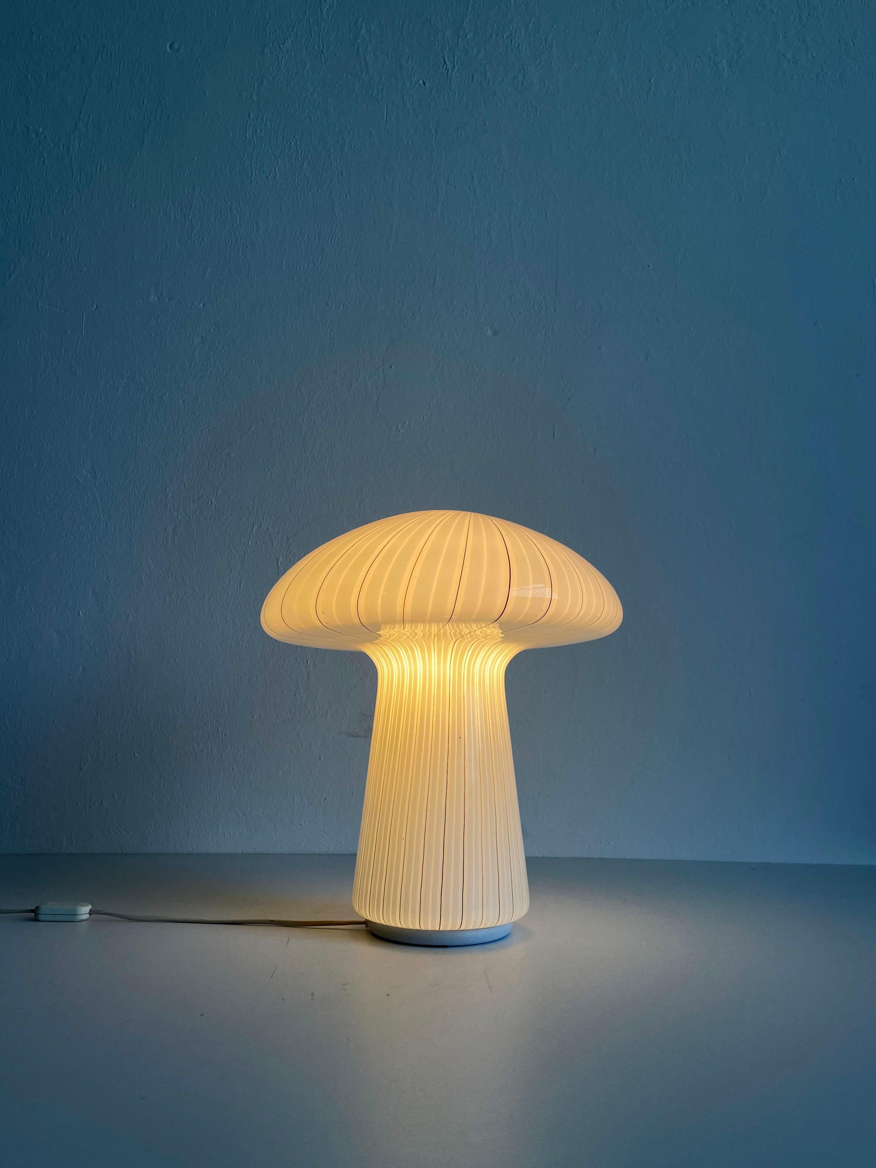 Beautiful large Italian Murano glass mushroom table lamp in very good original condition. 
The lamp has one E27 lamp socket (it comes without the bulb) and a standard European 2-pin plug

The glass shows minimal traces of cosmetic wear.