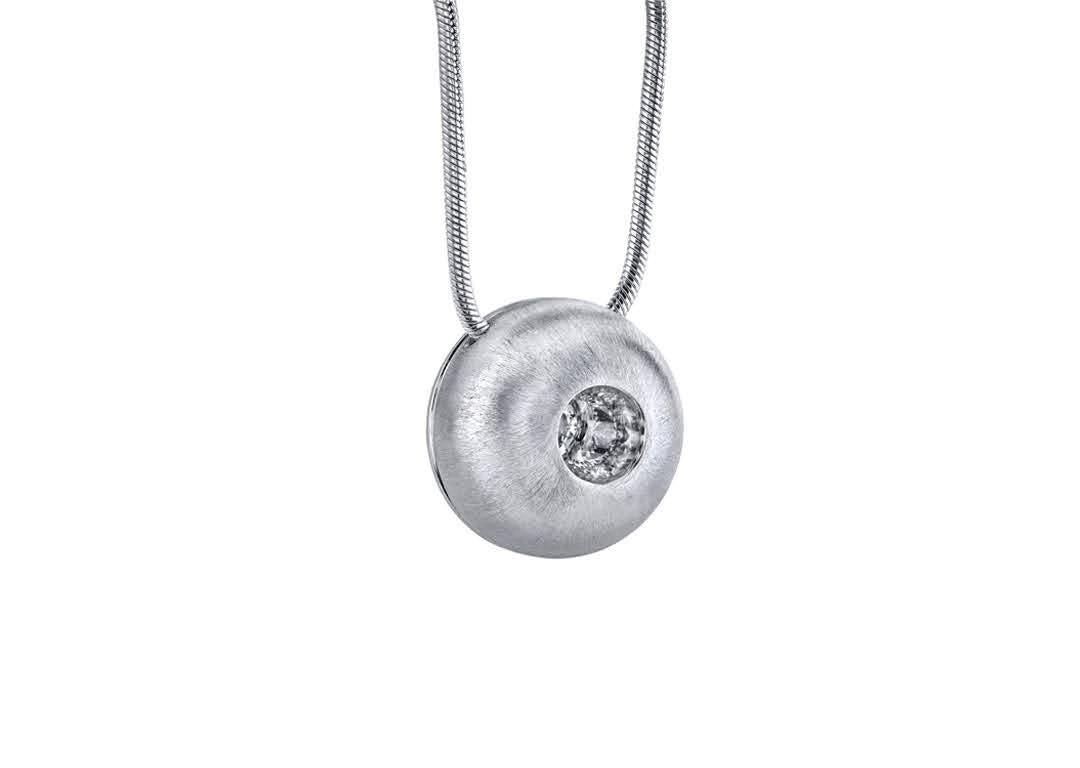 This White Sapphire in Large White Gold Dome Pendant, part of our Power Series, is a symbolic design inspired by the idea of looking inward, the notion of what a person needs is already inside of them. The clean and classic lines are imaginative,