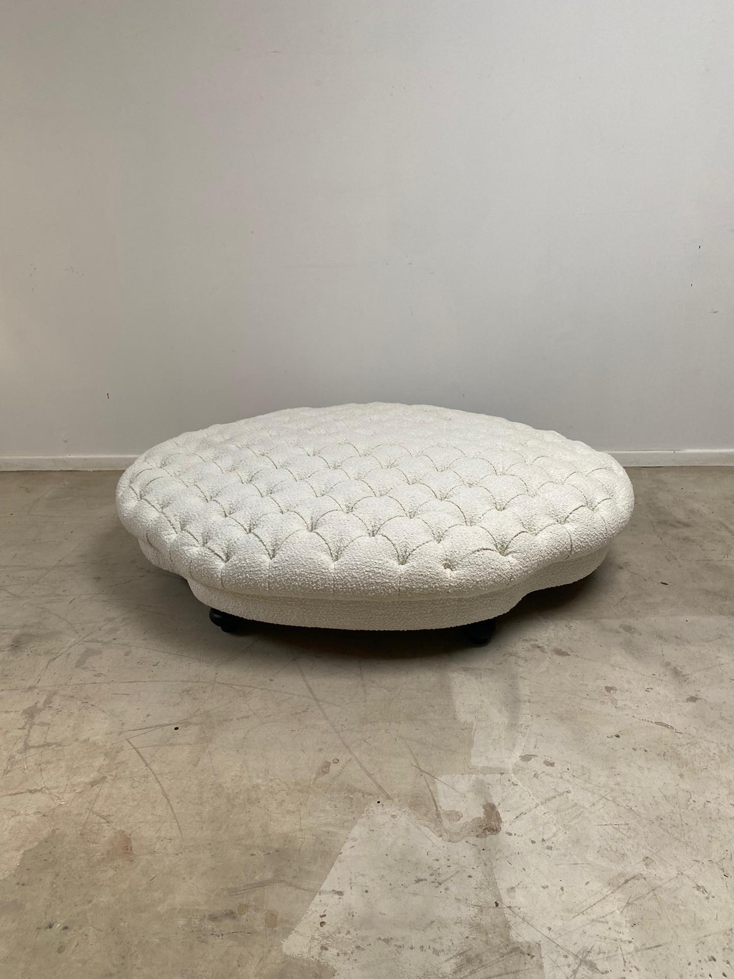 Nice large ottoman covered with a new white bouclette fabric. Black wood feet.