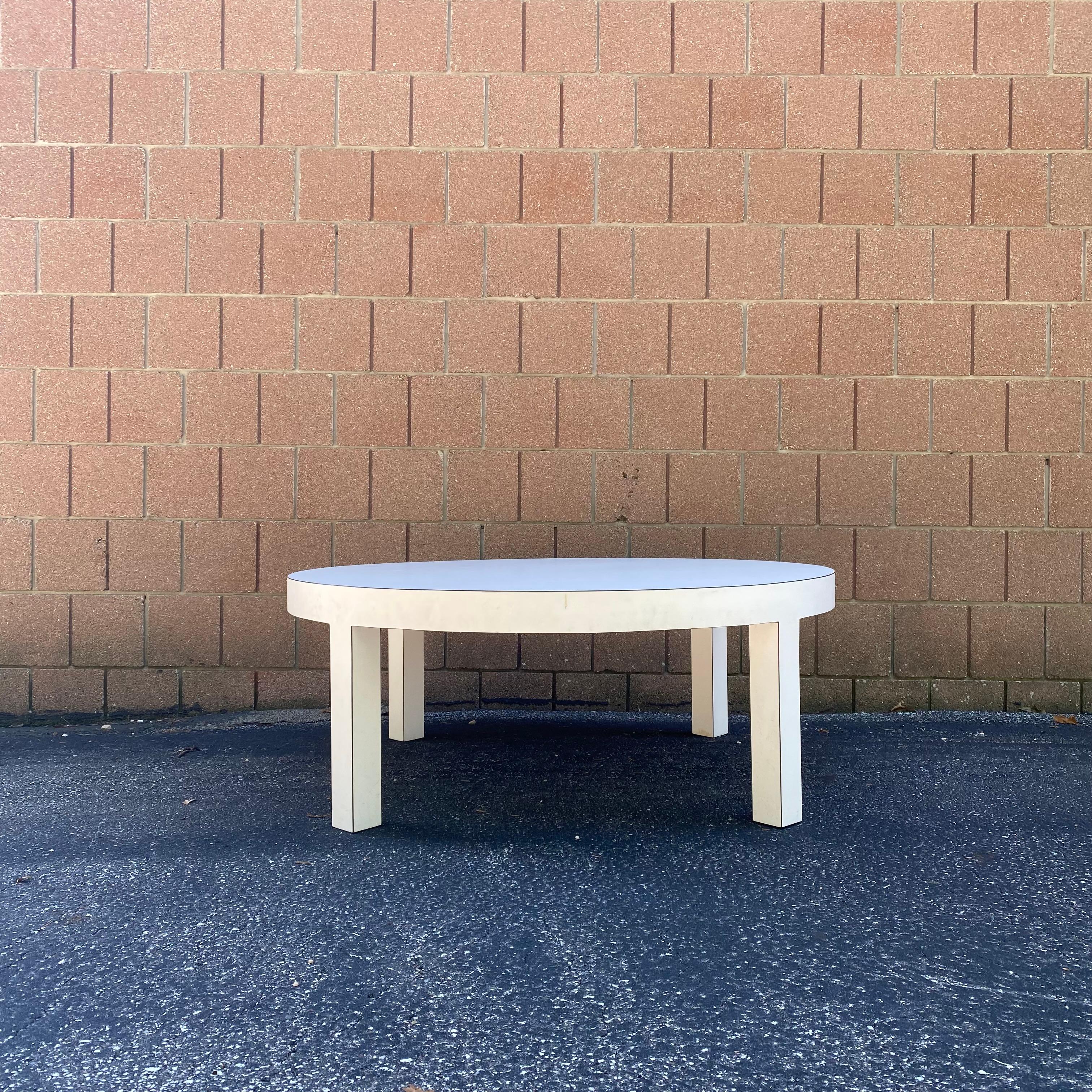 This is a fantastic round white laminate coffee table produced by Ray Arthur Inc., ca. 1970's. It has sort of a postmodern feel, but could also work with Midcentury modern tastes. It's simple and beautiful - can go with anything. 

Dimensions: 42