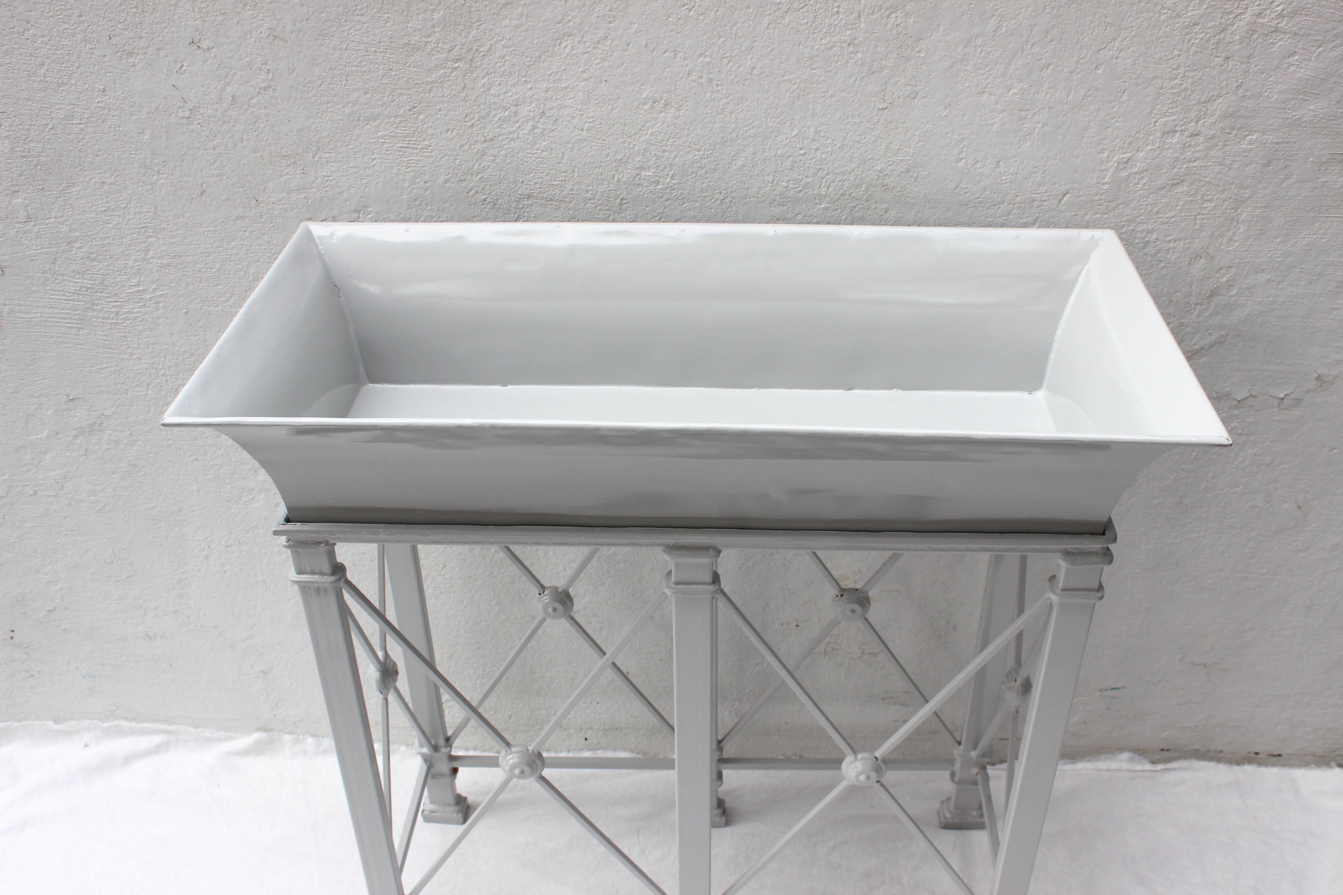 Two-piece metal planter newly painted in white.