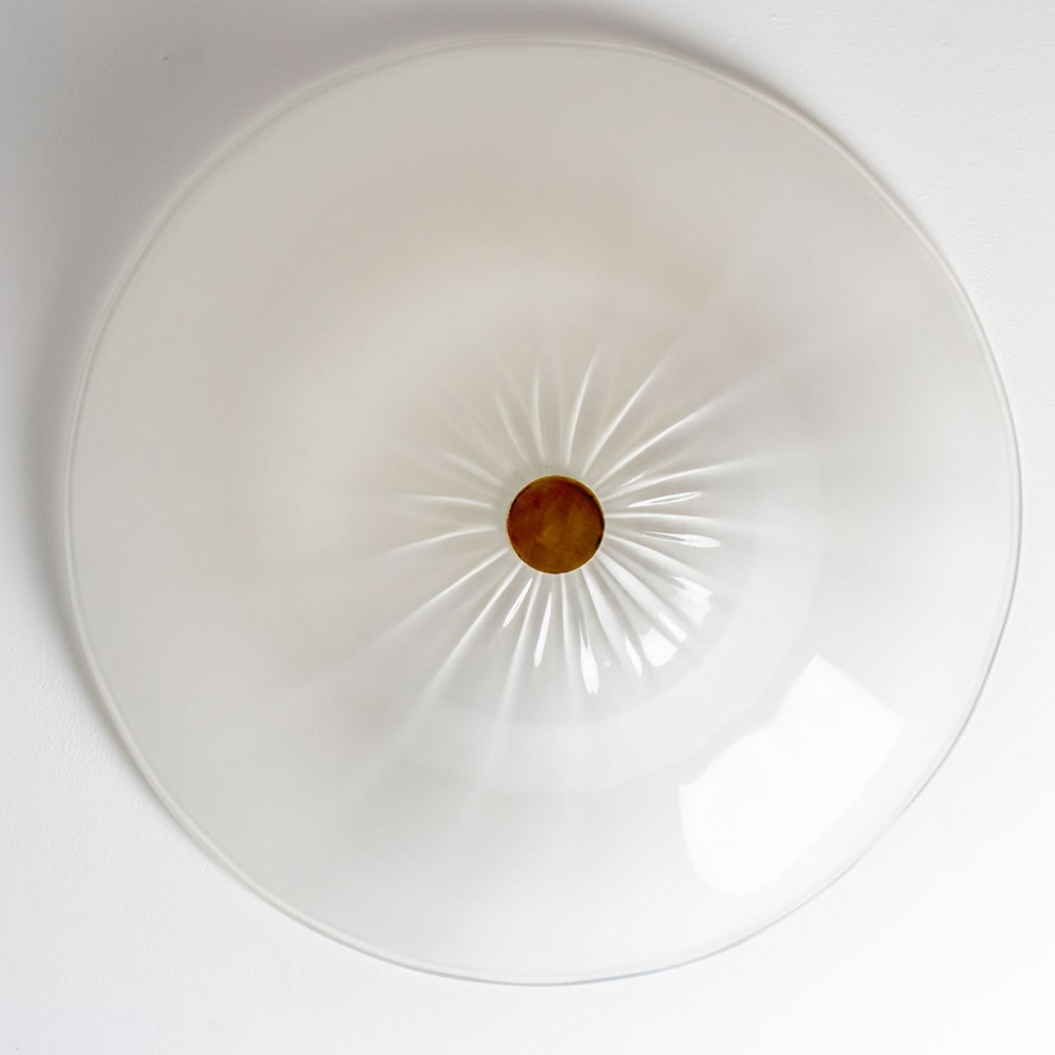 Large beautiful flush mount by J.T Kalmar. Manufactured in Austria, Europe, around 1970. Very elegant shape in white opaline glass.
The fixture shows a brass detail in the middle of the light. It fills the room with a soft, warm glow.

The flush