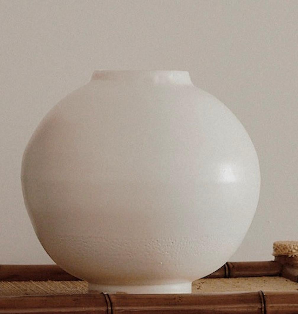 An anonymous white surface portraying a sense of purity, this contemporary moon jar is especially refined in form and slightly imperfect shape. 
9 x 9 in (3 3/8 in opening)