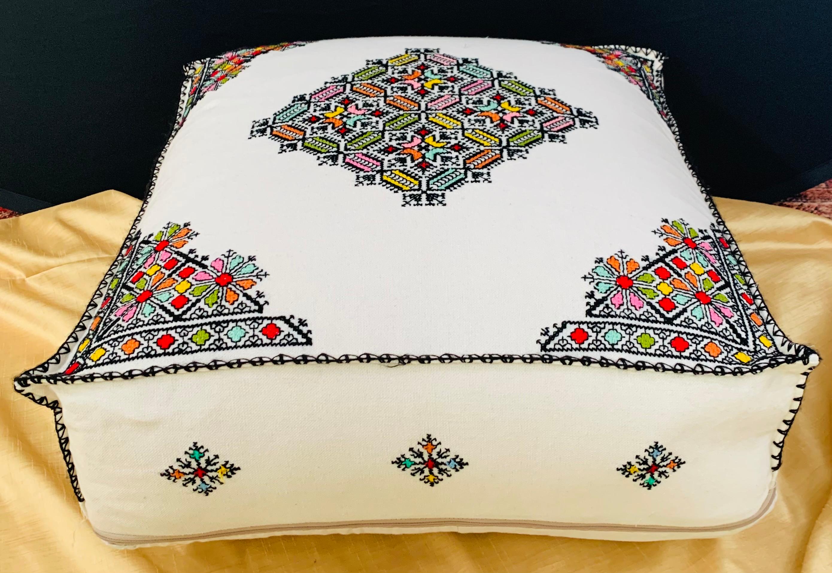 A large handwoven Moroccan white ottoman, cushion or pouf in a square shape. This eye-catching ottoman or pouf will lend an air of exotic majesty to your den or living room. Handcrafted by master artisans in the city of Fes and featuring an ornate