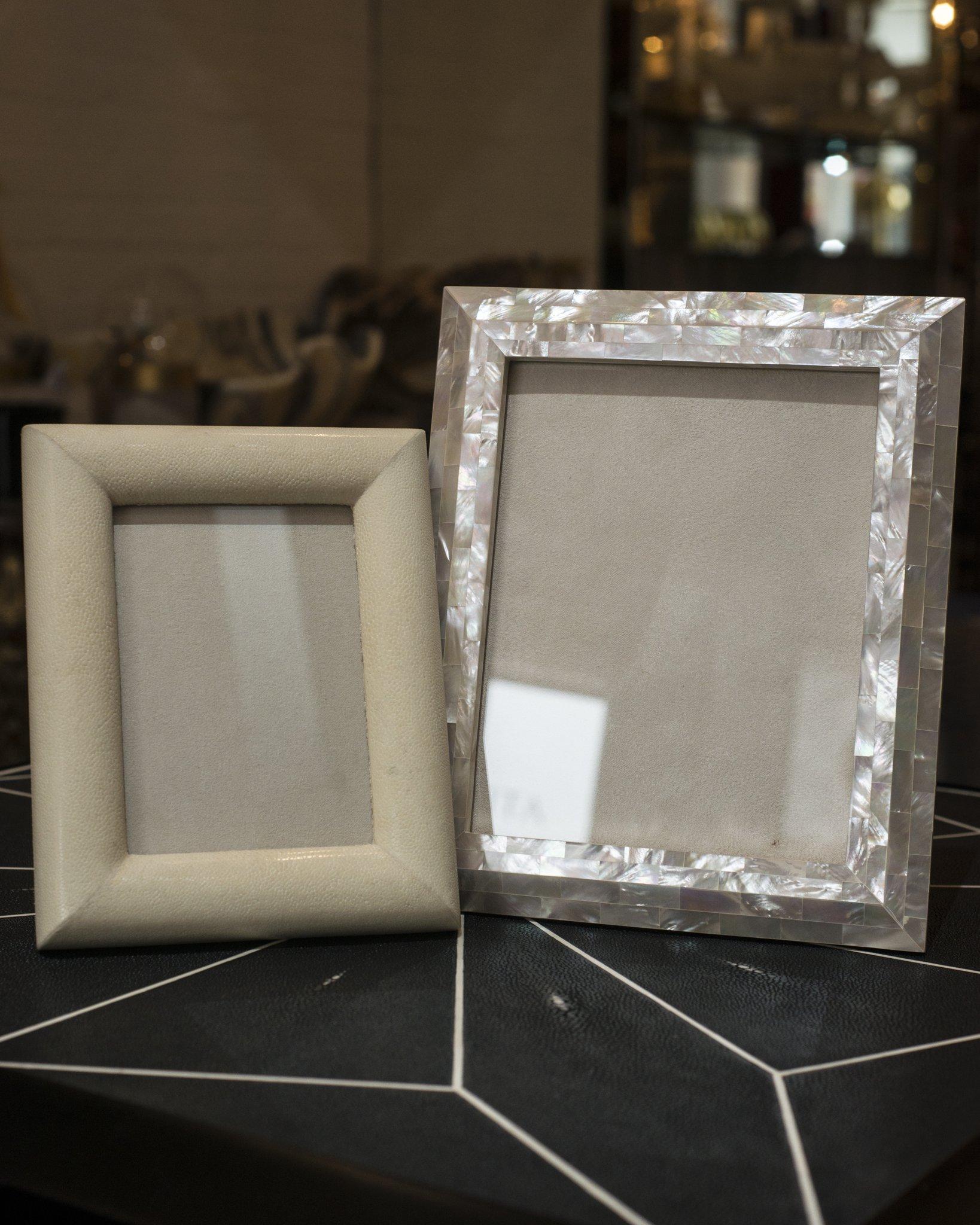 A large picture frame entirely inlaid with white Akoya mother of pearl on a walnut base, backed in suede. A picture frame as precious as the memory you may put inside.