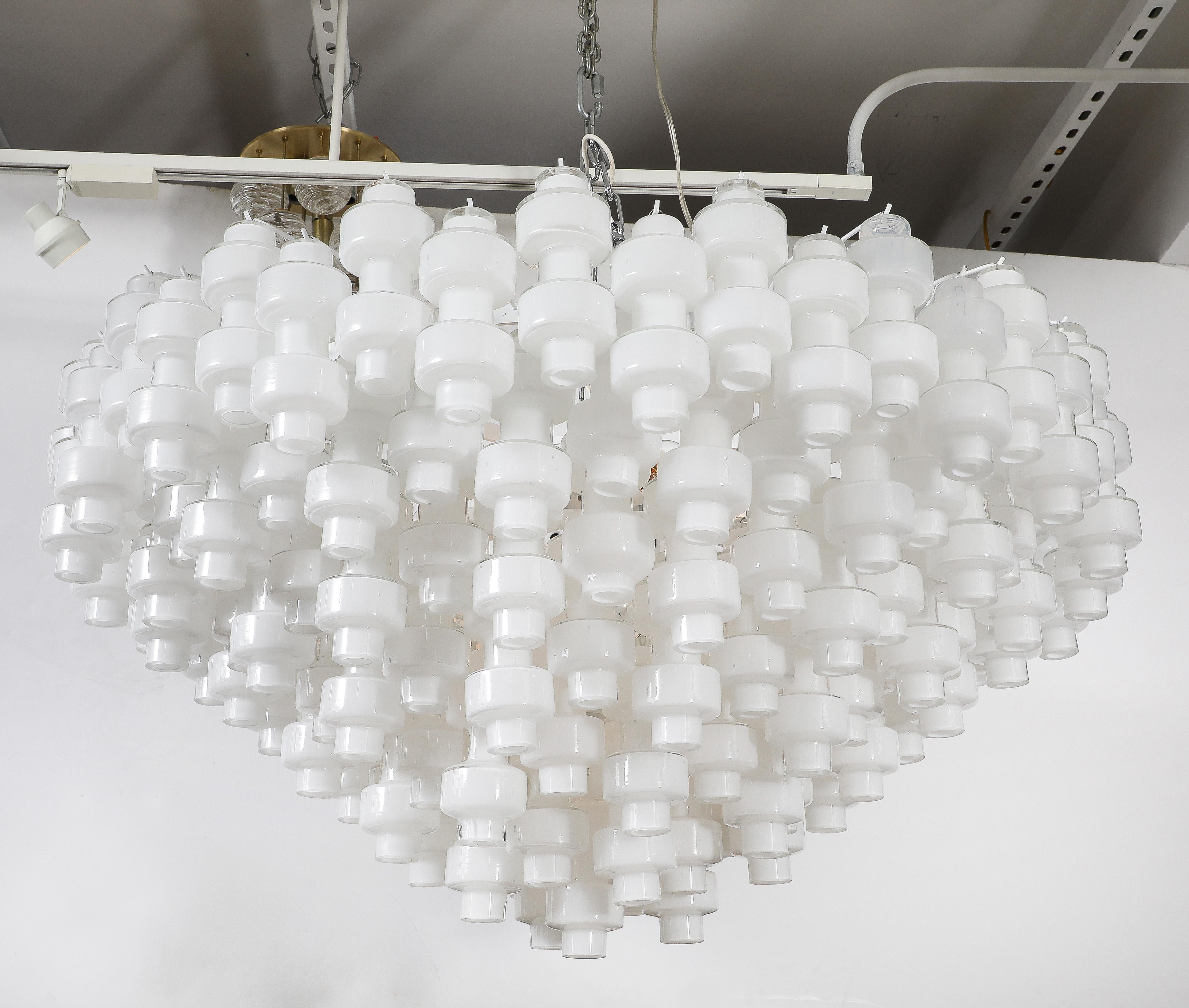 Monumental white Murano glass chandelier composed of barbell shaped glass elements, suspended on a chromed frame and chain. Wired for use in the USA. 