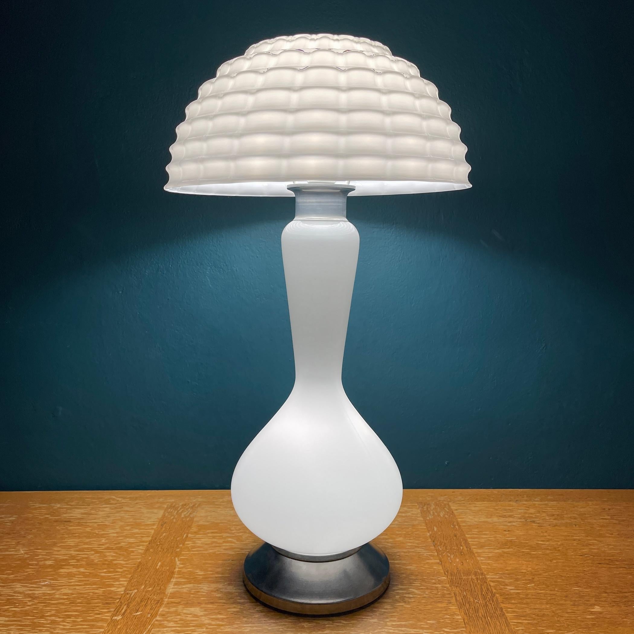 Huge magnificent swirl Murano glass table lamp Mushroom made in Italy in the 1970s. The elegance of the classic murano glass makes this lamp a pleasure to look at. It has one light bulb above and one light bulb in the base. The lamp consists of two