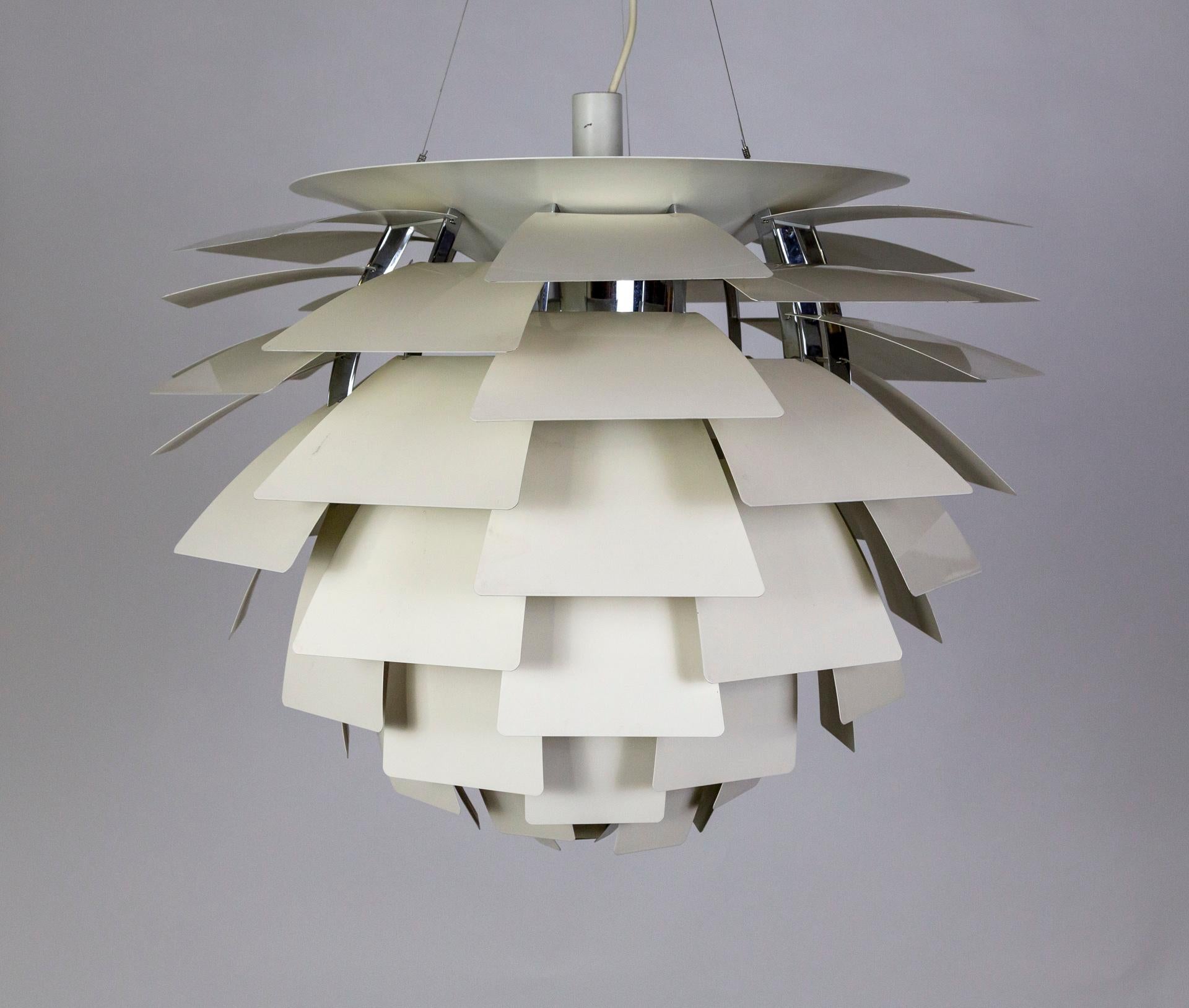 The PH Artichoke pendant light was designed in 1958 by Poul Henningsen in Copenhagen for Louis Poulson. Since then it has become an iconic, midcentury design and is continuously produced. The lamp consists of 72 handmade, white, lacquered aluminum