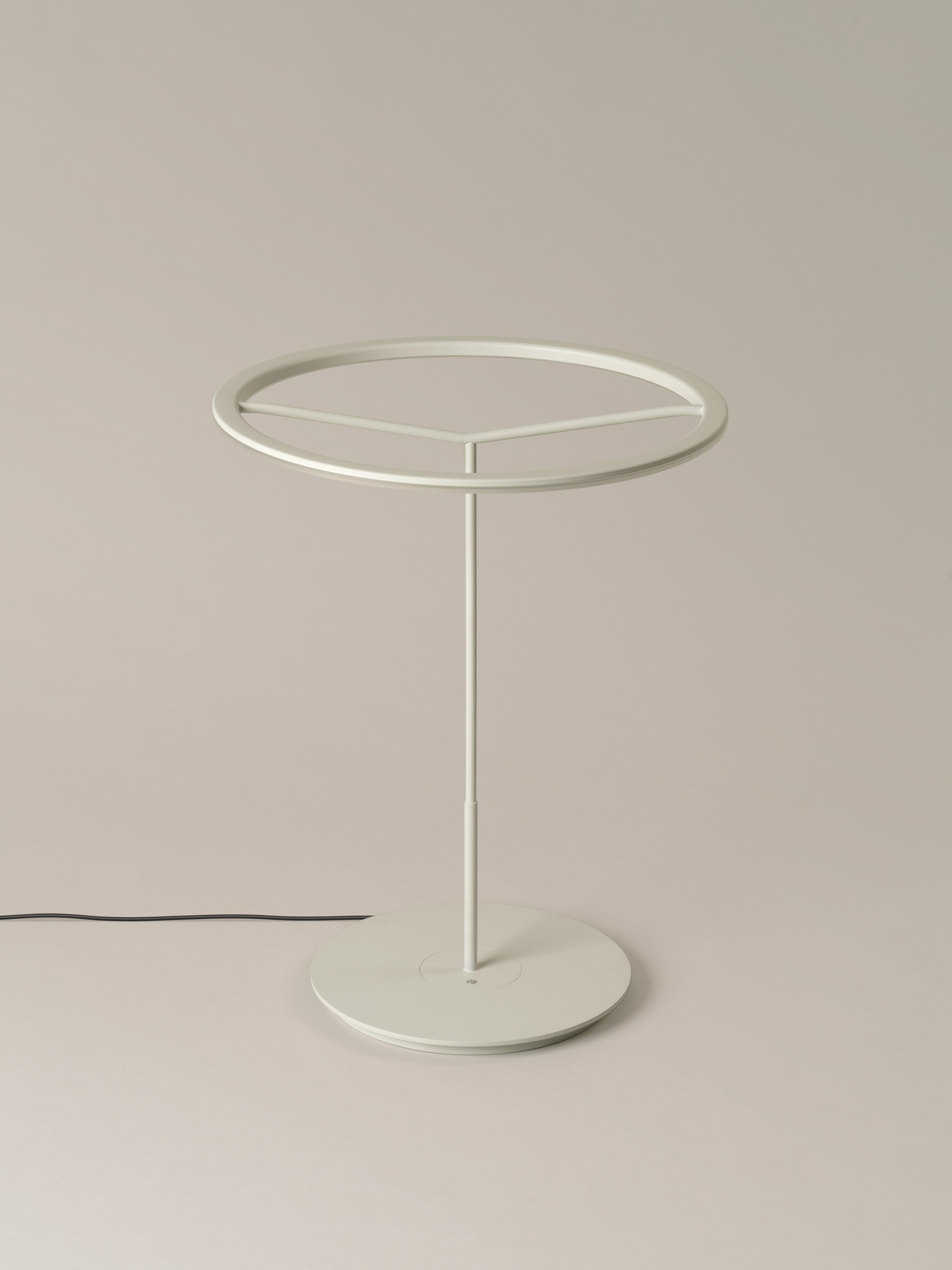 Large White Sin table lamp by Antoni Arola.
Dimensions: D 45 x H 58 cm.
Materials: Metal.
Available in white or graphite, with or without shade.

A lamp that combines simplicity and technology to create a lucent ring of light suspended in the