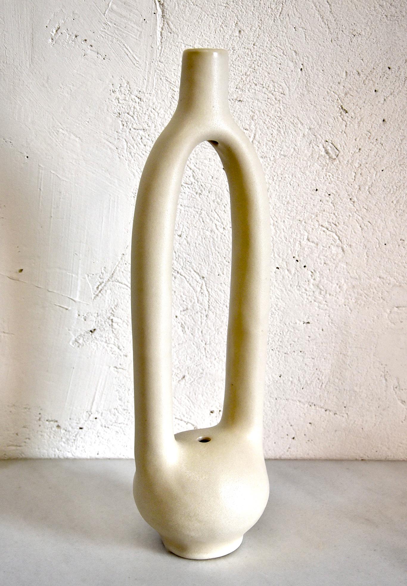 This single stem ceramic vessel by Simone Bodmer-Turner is slip cast in a white stoneware, and finished in a white slip with a satin matte finish.

Simone Bodmer-Turner is a ceramic artist and sculptor working in Brooklyn, New York. 

She