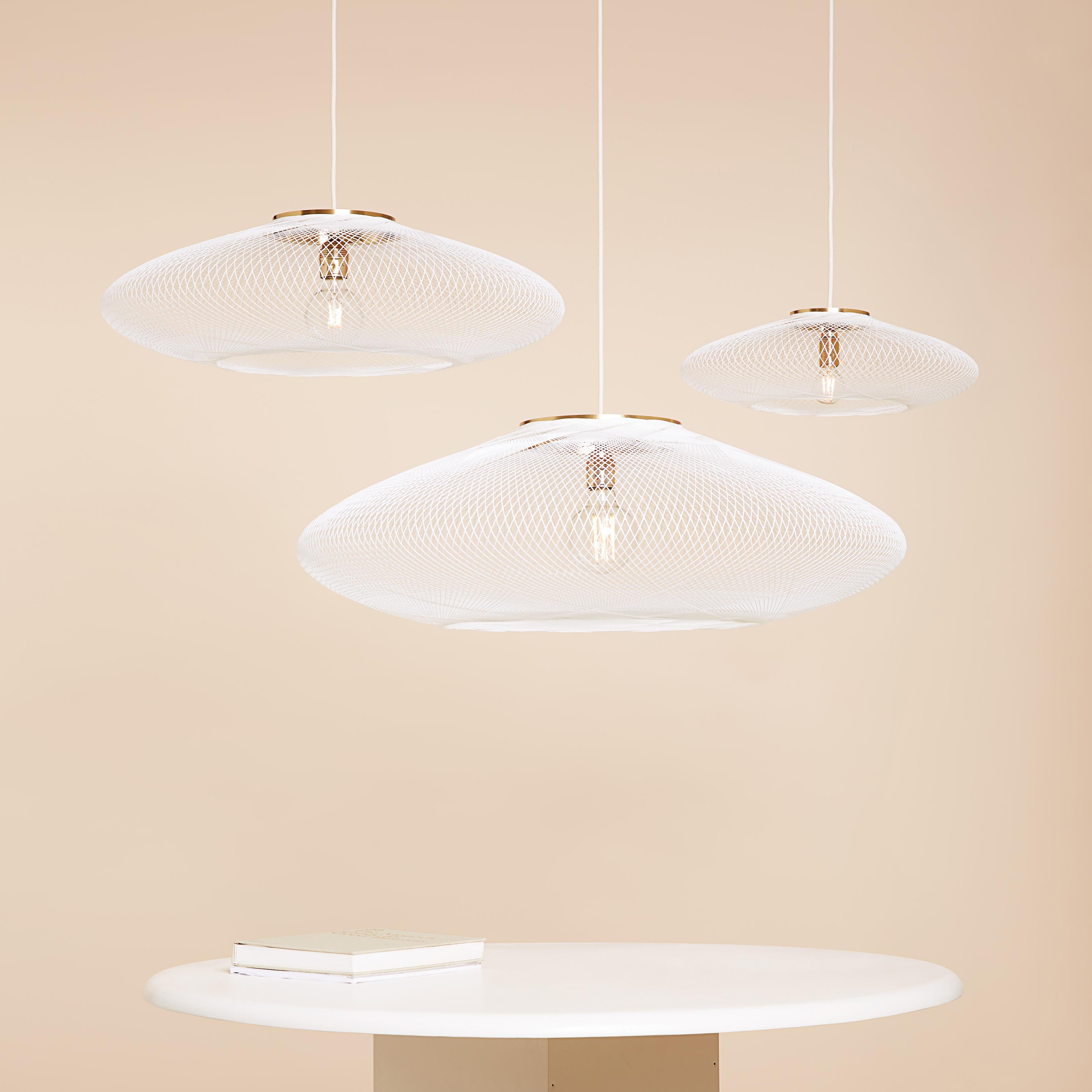 Large White UFO pendant lamp by Atelier Robotiq
Dimensions: D 80 x H 24 cm
Materials: Resin-impregnated industrial fiber, brass.
Available with holder in copper/ brass/ black coated stainless steel.
Available in different colors, 3 sizes, and in