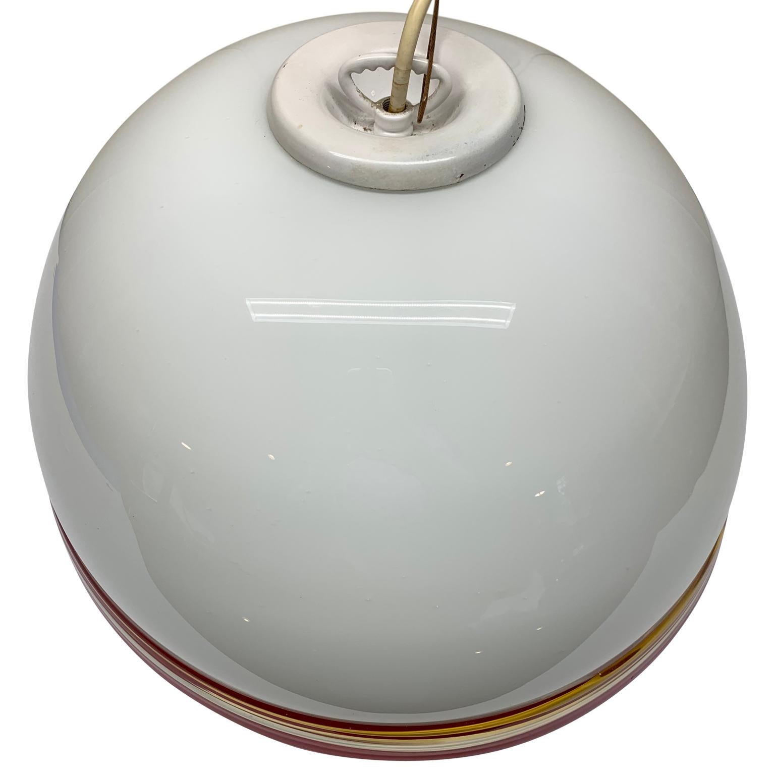 Large white, yellow and red Italian Murano Art glass dome pendant light.

Attributed to Effetre International, Italy.
The Murano glass is predominantly opaline white with clear, red, yellow art glass trim.
 