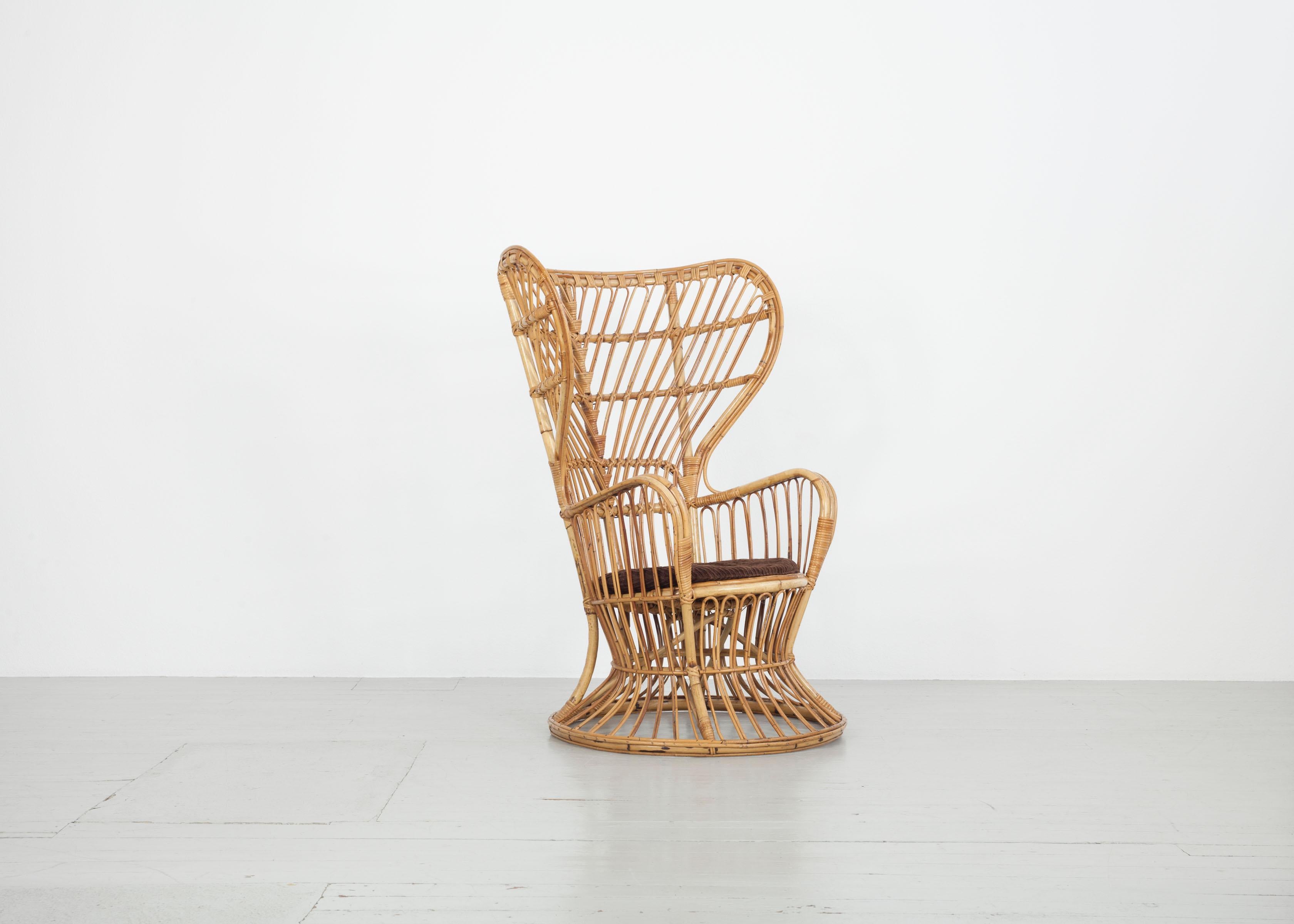 

This extremely comfortable wicker armchair was presumably designed by Lio Carminati and Gio Ponti in the 1950s and manufactured by Vittorio Bonacina in Italy. It has a high backrest and curved constructions made of bamboo and metal. The piece of