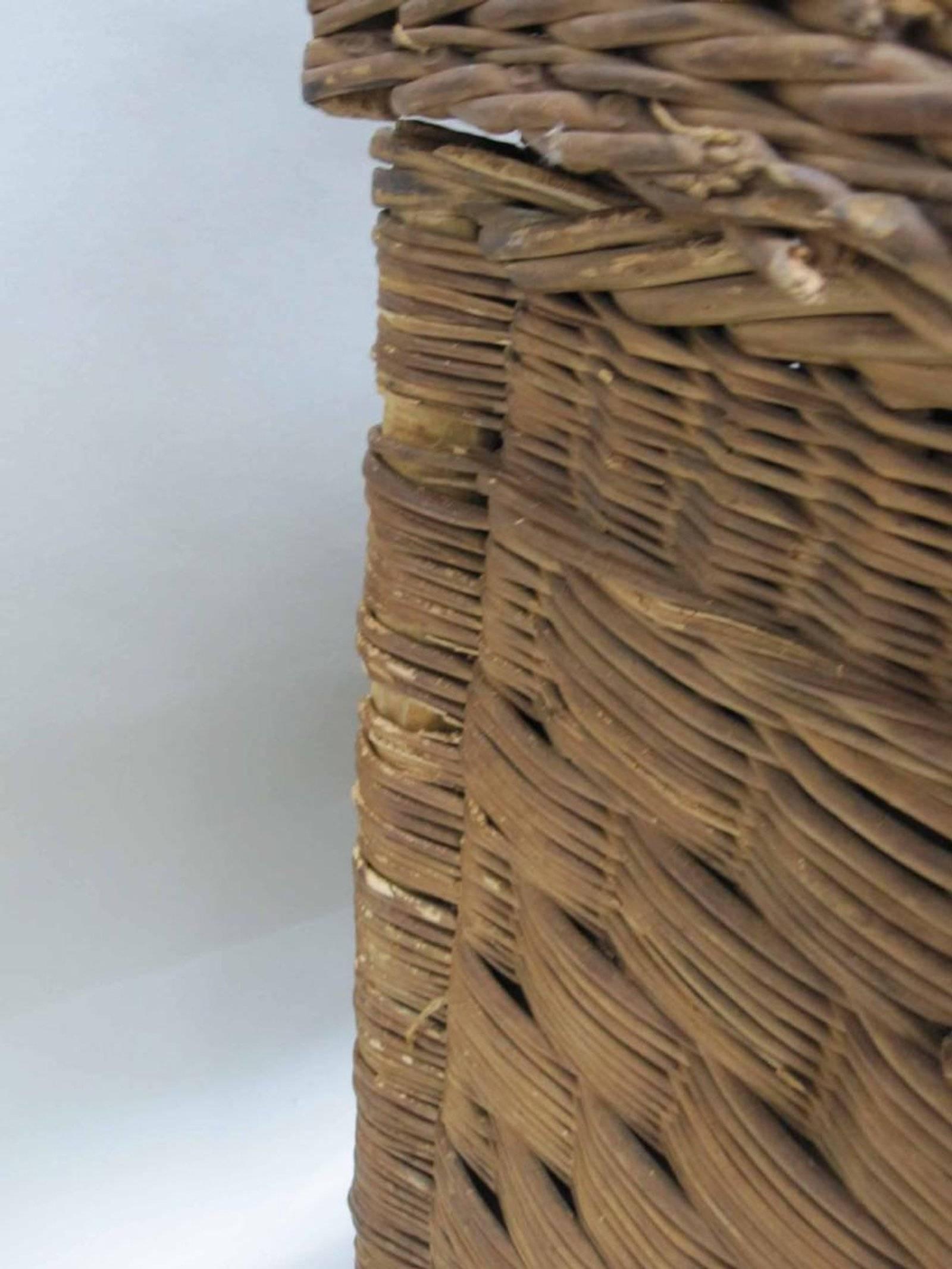 Woven willow basket trunk. Although it shows distress it can still be charming and very usable as blanket chest, storage, or at the foot of a bed. Trunk has removable top. Measures: 37
