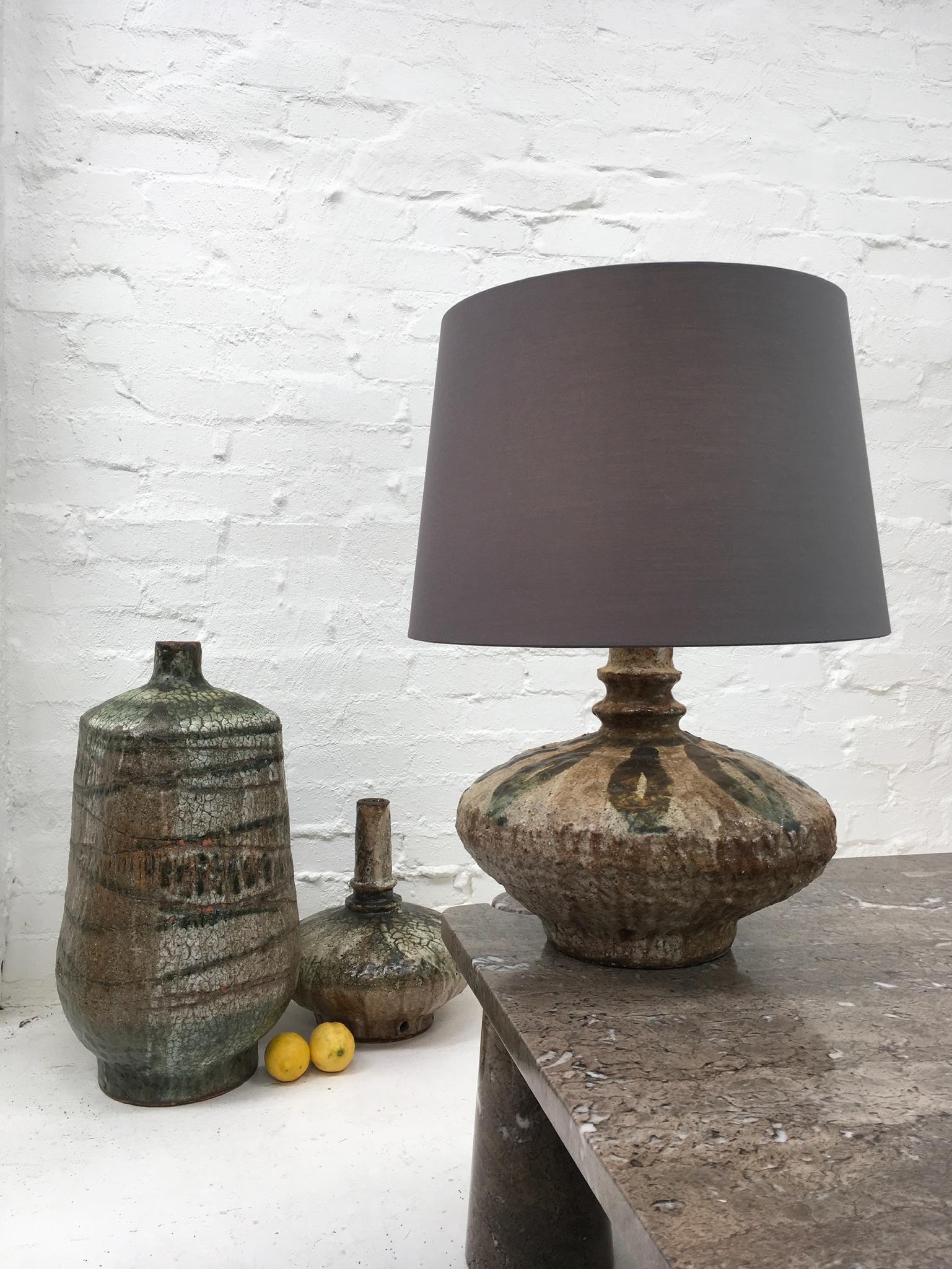 Large and wonderfully shaped earthenware lamp is fully wired, tested and tagged safe for use. It’s a coil pot construction in the style of Dan Arbeid. The wide shape and mineral rustic glaze make this a very attractive lamp.

Based on ancient Middle