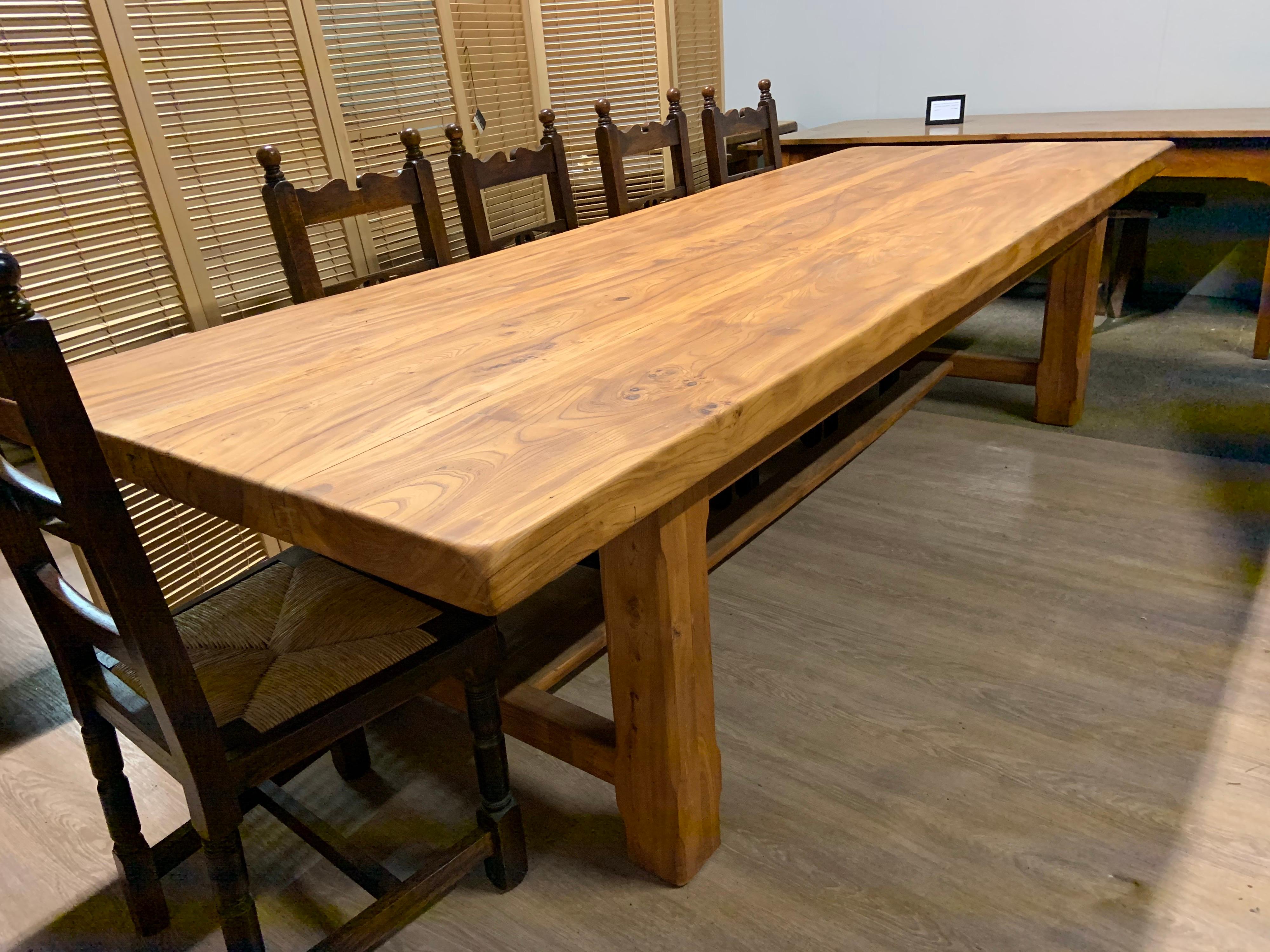 Large rustic wide pale elm Farmhouse table with substantial well figured thick top, consisting of three planks. The top sits on four sturdy thick jointed elm legs united by an H stretcher.